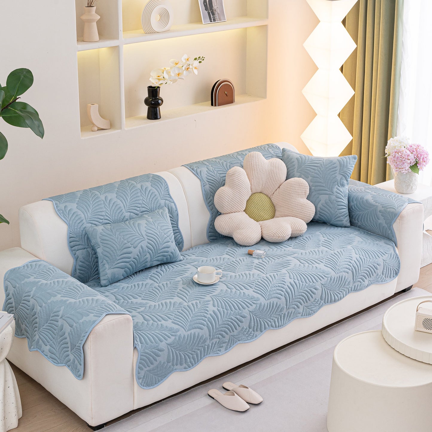 Sofa Cover for Leather & Fabric Couches, 3D Leaf Embossed Quilted Furniture Covers on white sofa with decorative pillows.