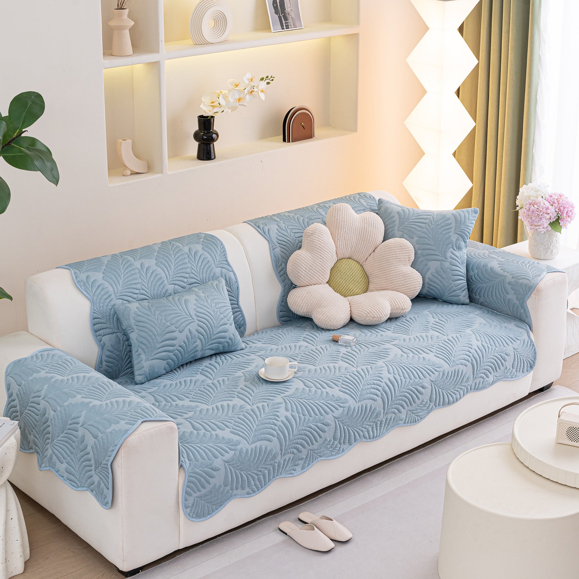 Sofa Cover for Leather & Fabric Couches, 3D Leaf Embossed Quilted Furniture Covers on white sofa with decorative pillows.