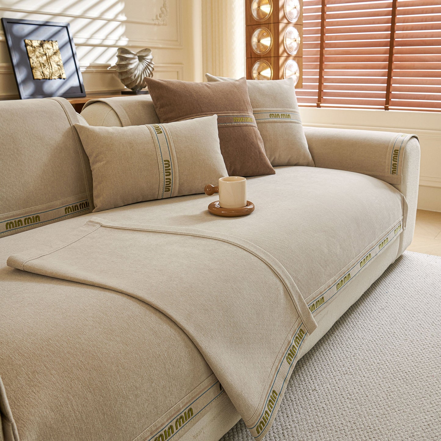 Chenille Sofa Cover Pet Mat, Non-Slip Couch Protector for Sectional & L-Shaped Sofas in living room setting with pillows.