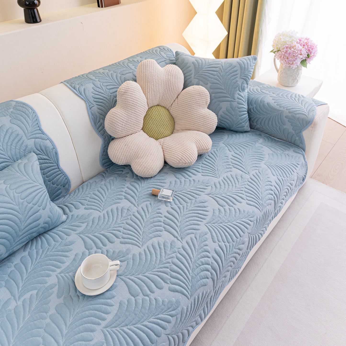 Sofa Cover for Leather & Fabric Couches, 3D Leaf Embossed Quilted Furniture Covers on a couch with floral pillow.