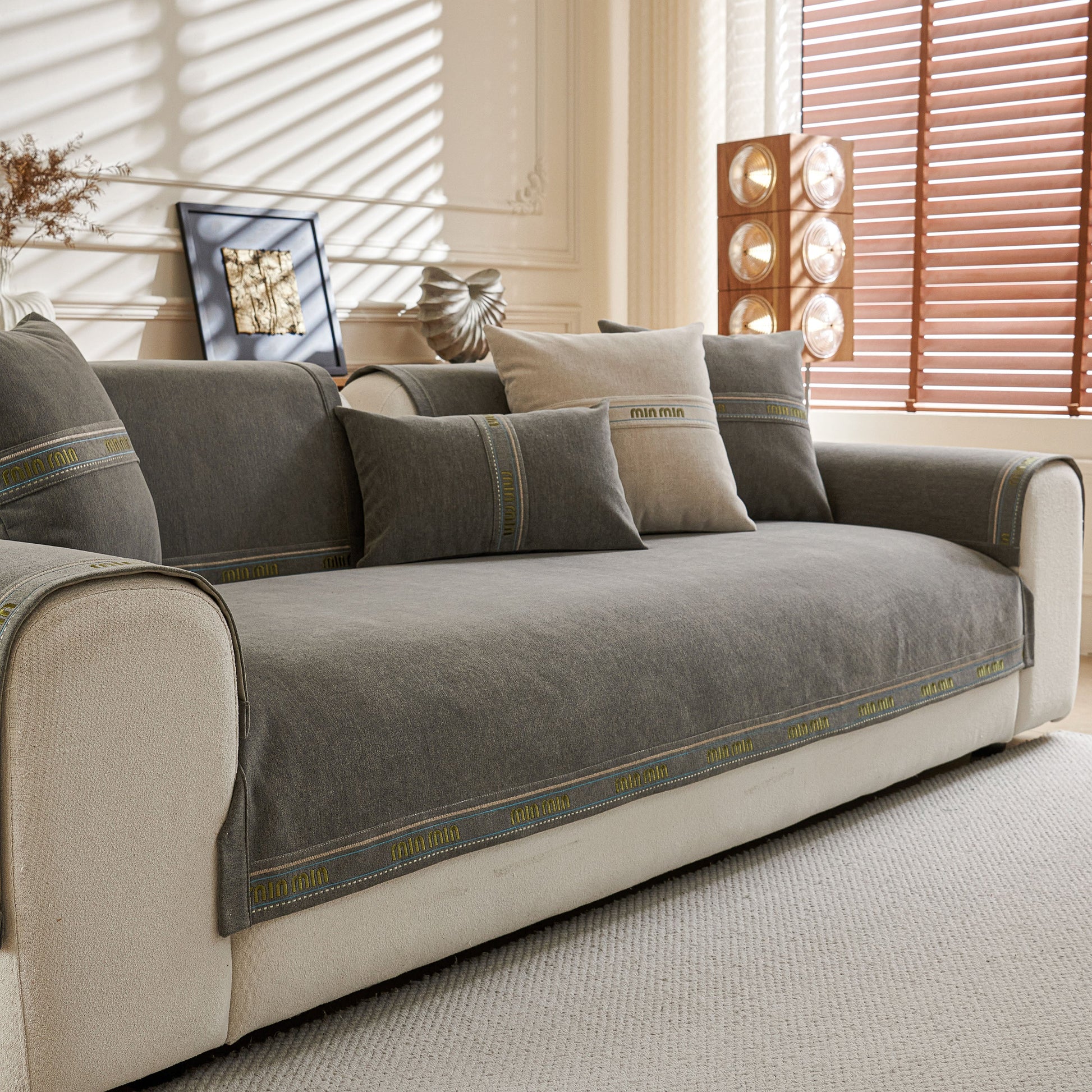 Chenille Sofa Cover Pet Mat, Non-Slip Couch Protector for Sectional & L-Shaped Sofas shown on a modern white couch in living room.