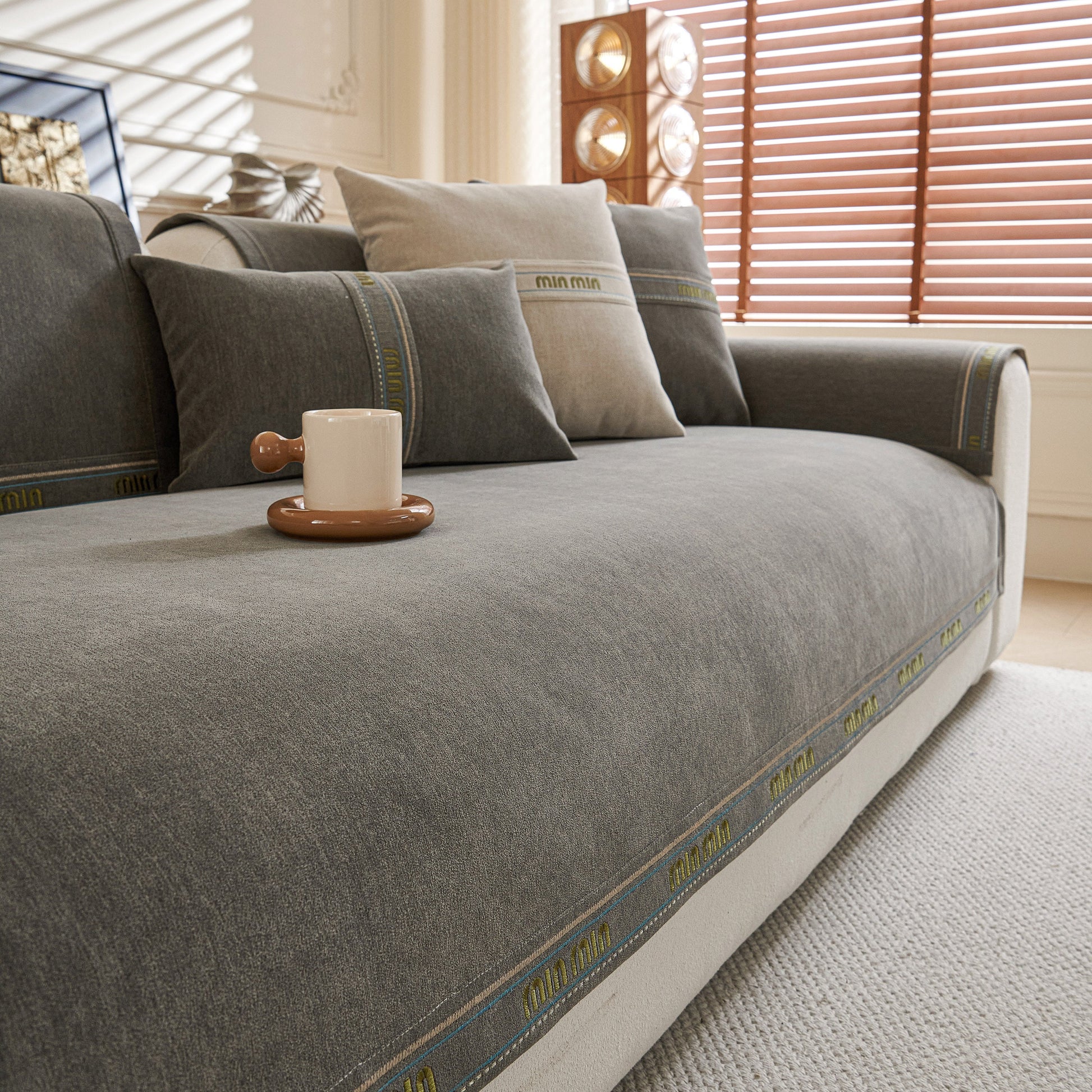 Chenille Sofa Cover Pet Mat, Non-Slip Couch Protector for Sectional & L-Shaped Sofas on grey sofa with decorative cushions.