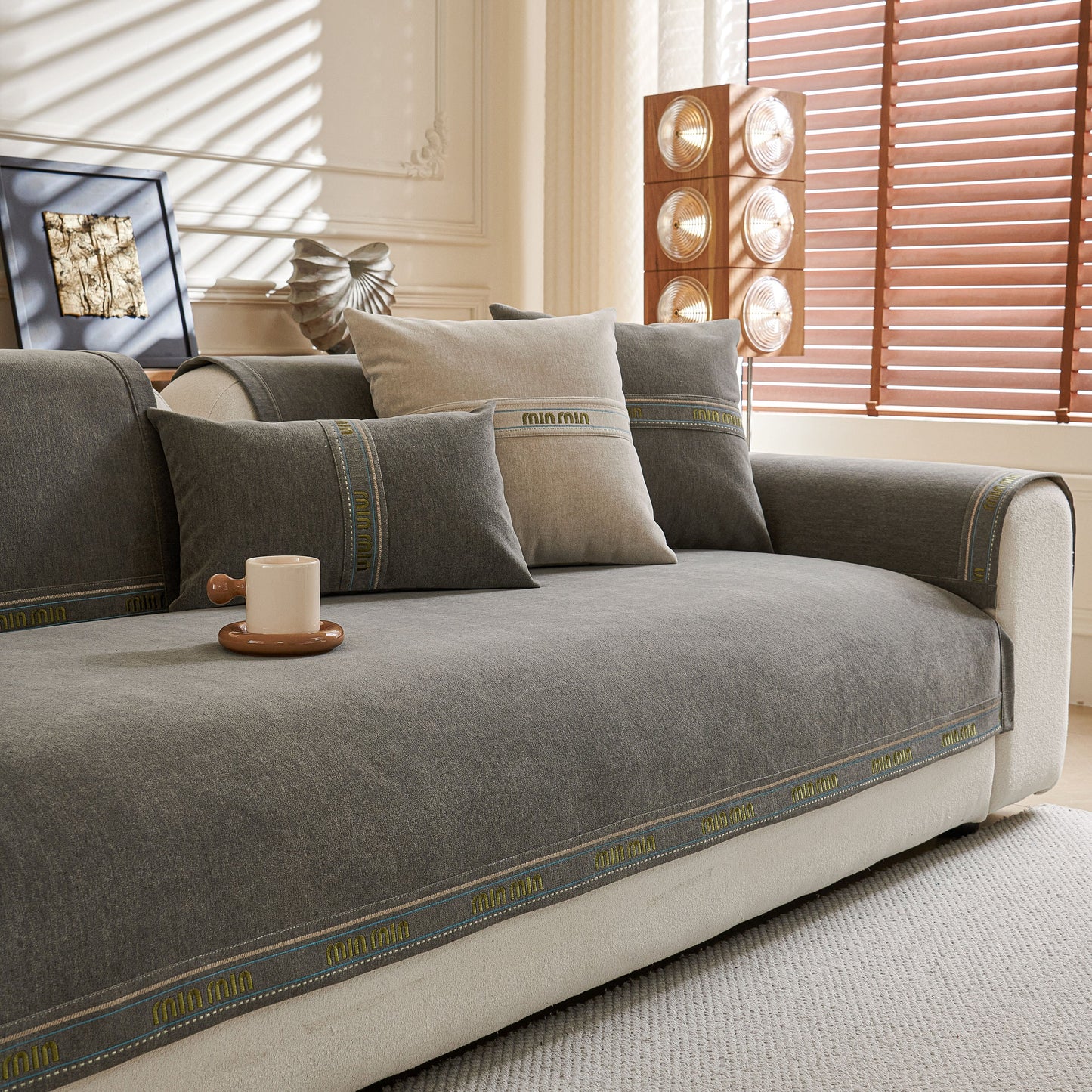 Chenille Sofa Cover Pet Mat, Non-Slip Couch Protector for Sectional & L-Shaped Sofas on grey couch in bright room.