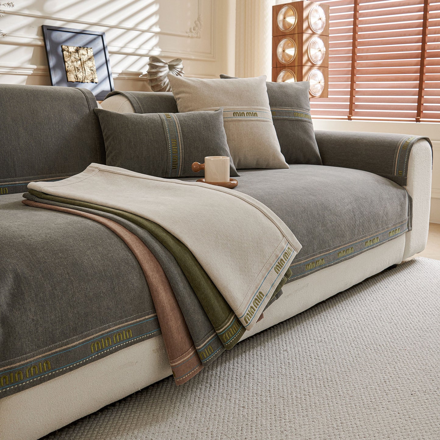Chenille Sofa Cover Pet Mat, Non-Slip Couch Protector for Sectional & L-Shaped Sofas on a grey couch with pillows and blankets.