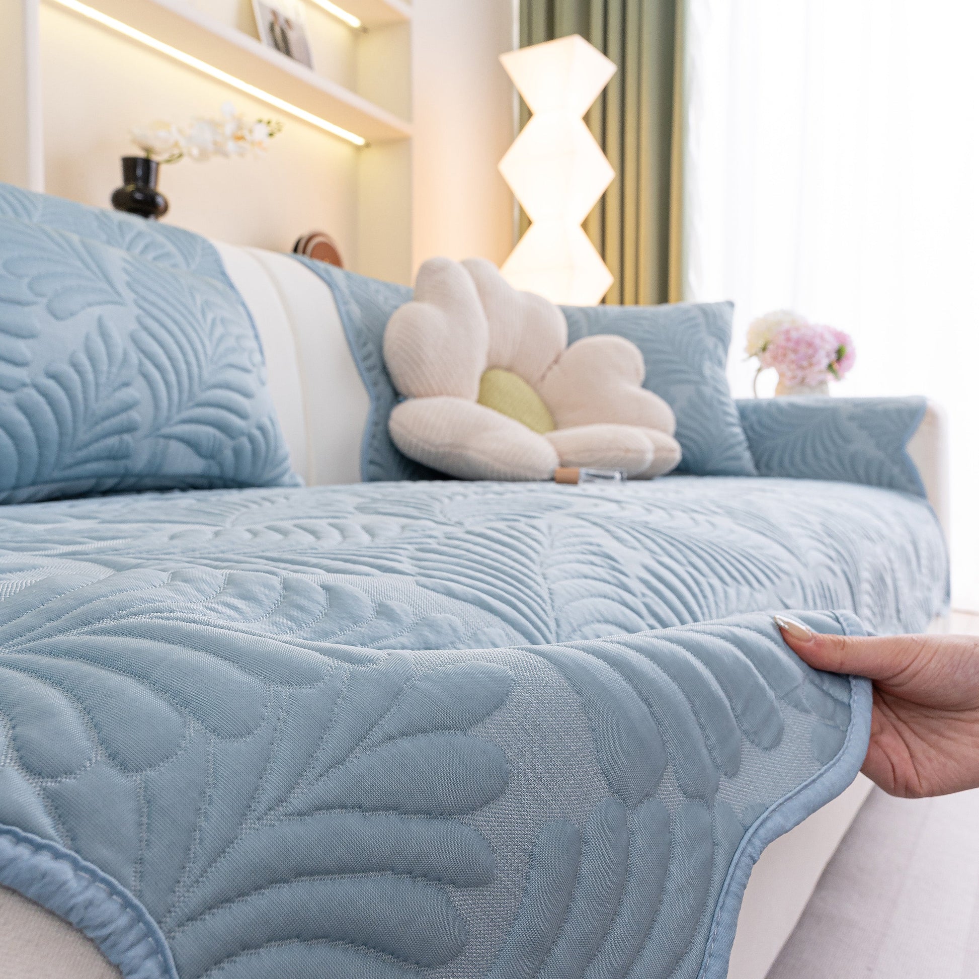 Sofa Cover for Leather & Fabric Couches, 3D Leaf Embossed Quilted Furniture Covers with anti-slip backing in a living room setting