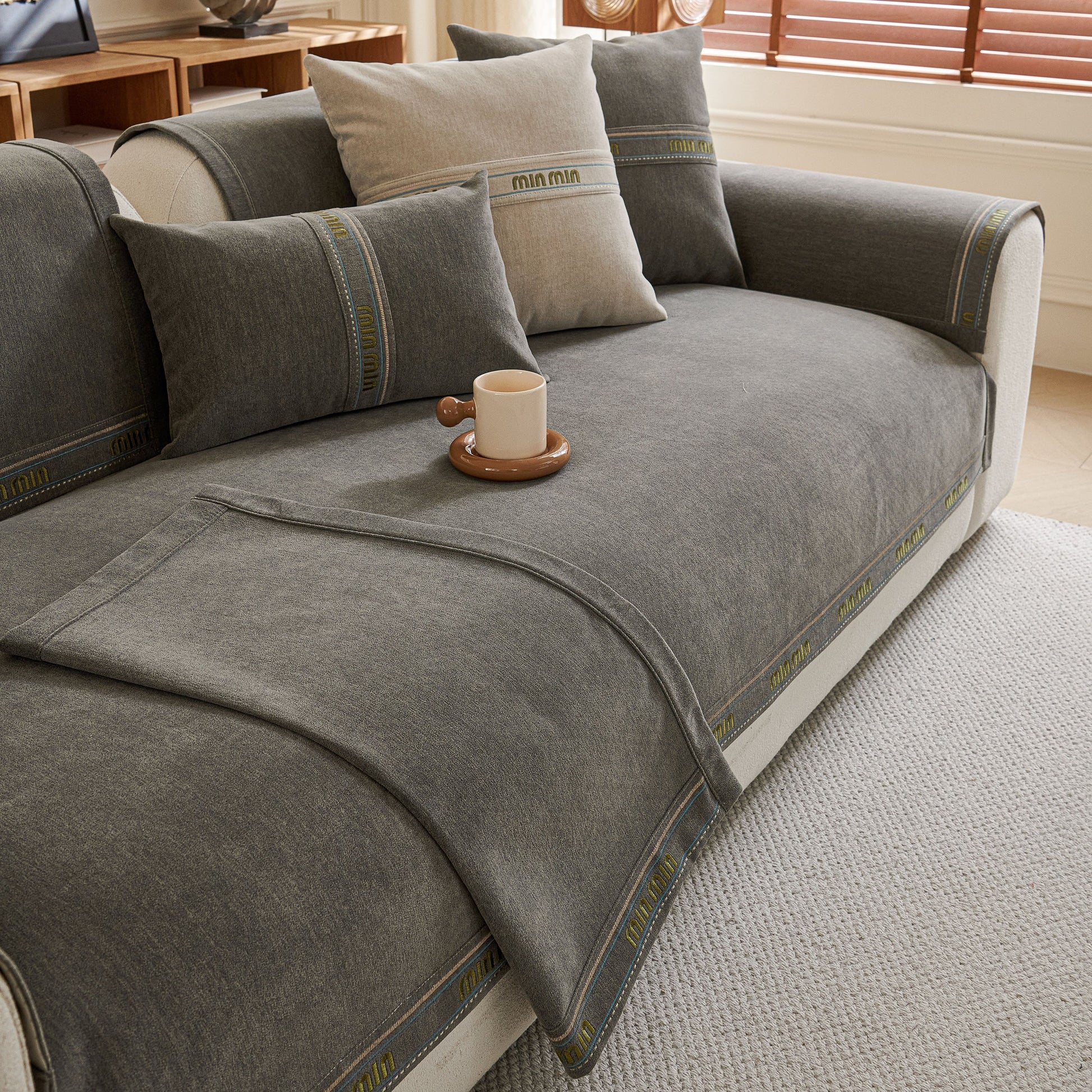 Chenille Sofa Cover Pet Mat, Non-Slip Couch Protector for Sectional & L-Shaped Sofas on a gray couch with pillows.