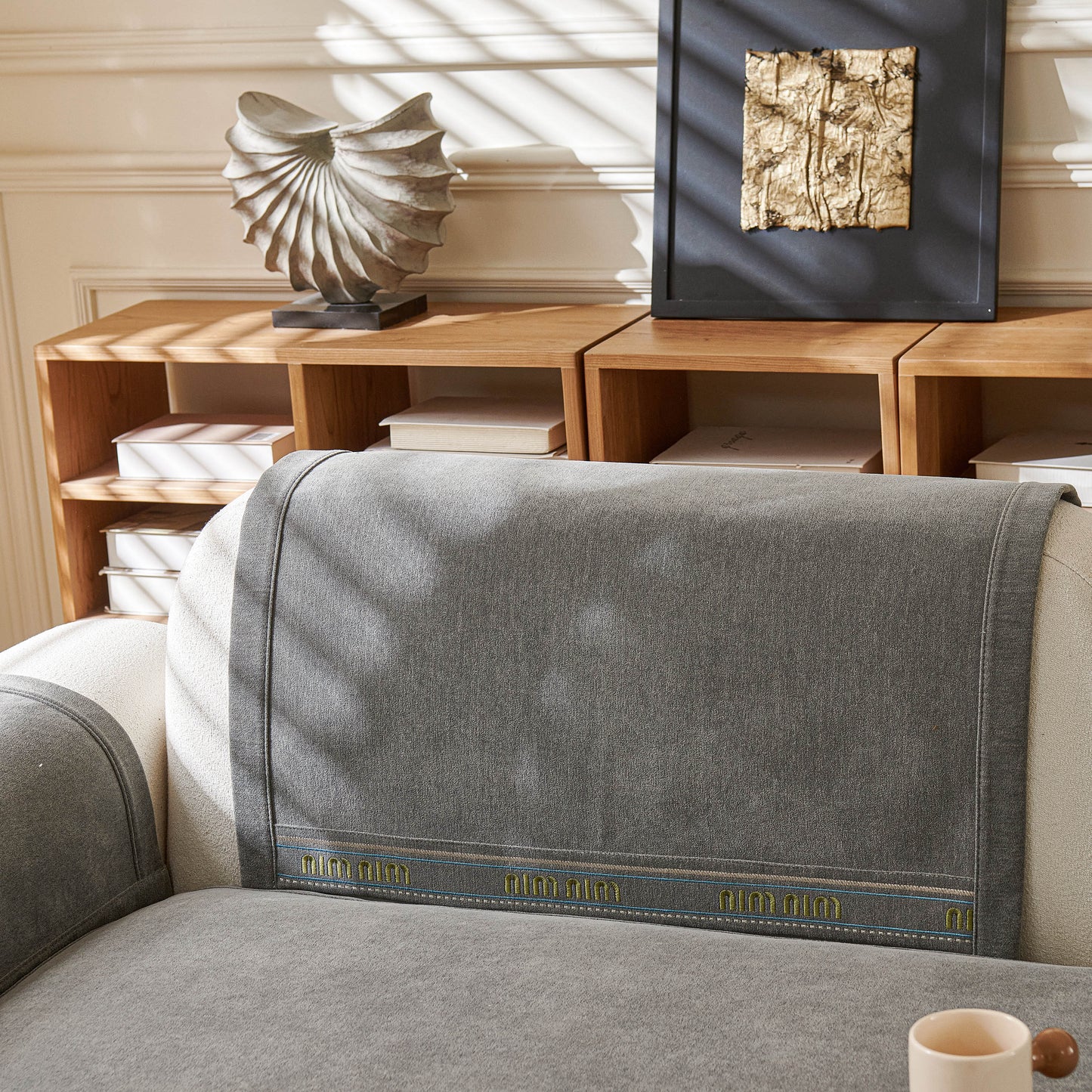 Chenille Sofa Cover Pet Mat, Non-Slip Couch Protector for Sectional & L-Shaped Sofas shown on a grey sofa in a cozy living room setting.