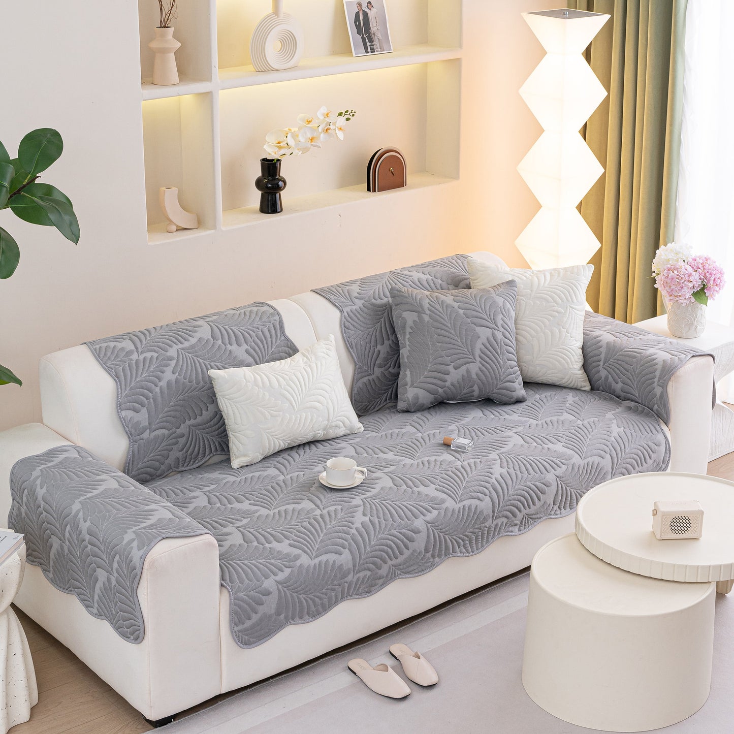 Sofa Cover for Leather & Fabric Couches, 3D Leaf Embossed Quilted Furniture Covers on a white sofa in a modern living room