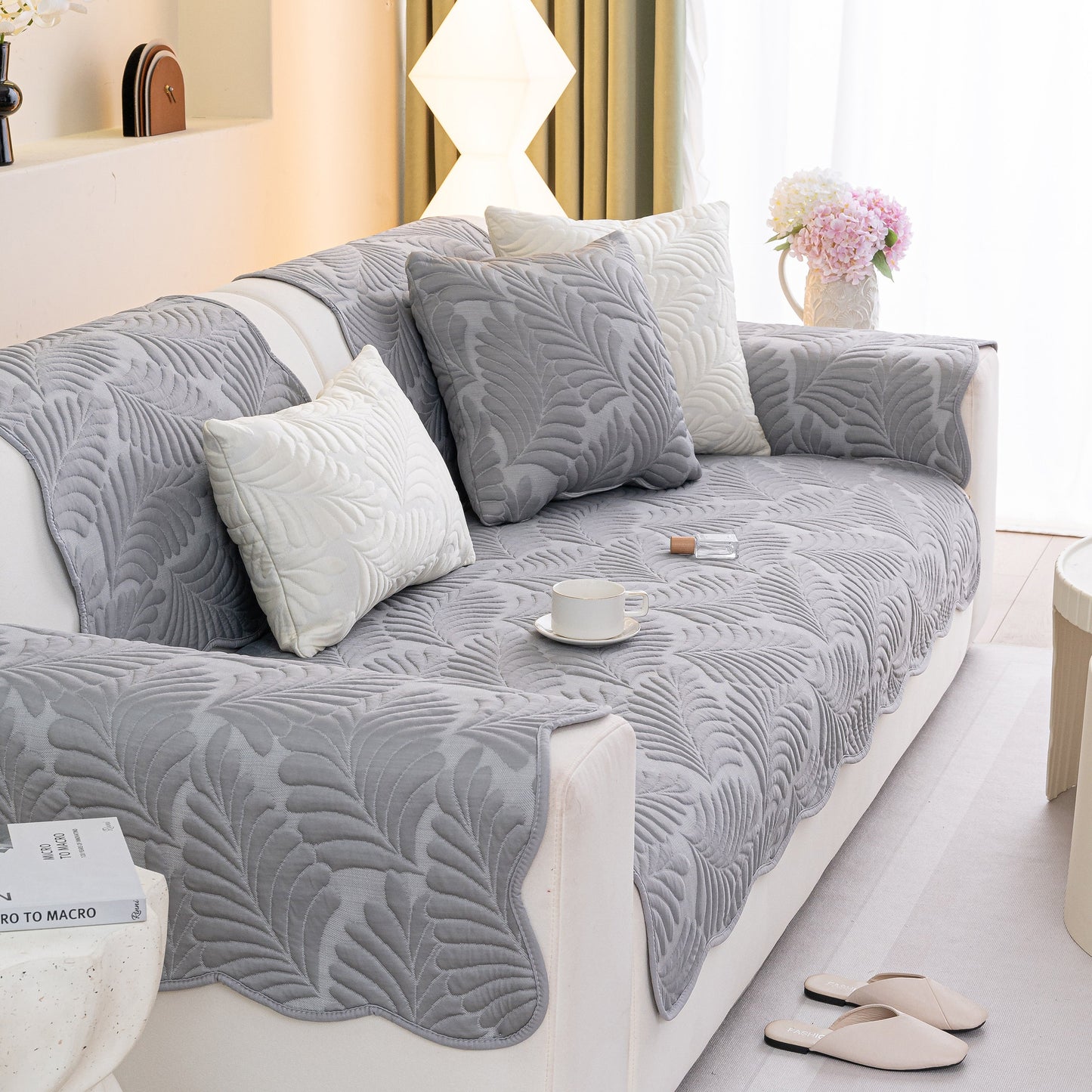 Sofa Cover for Leather & Fabric Couches, 3D Leaf Embossed Quilted Furniture Covers on a gray sofa with pillows
