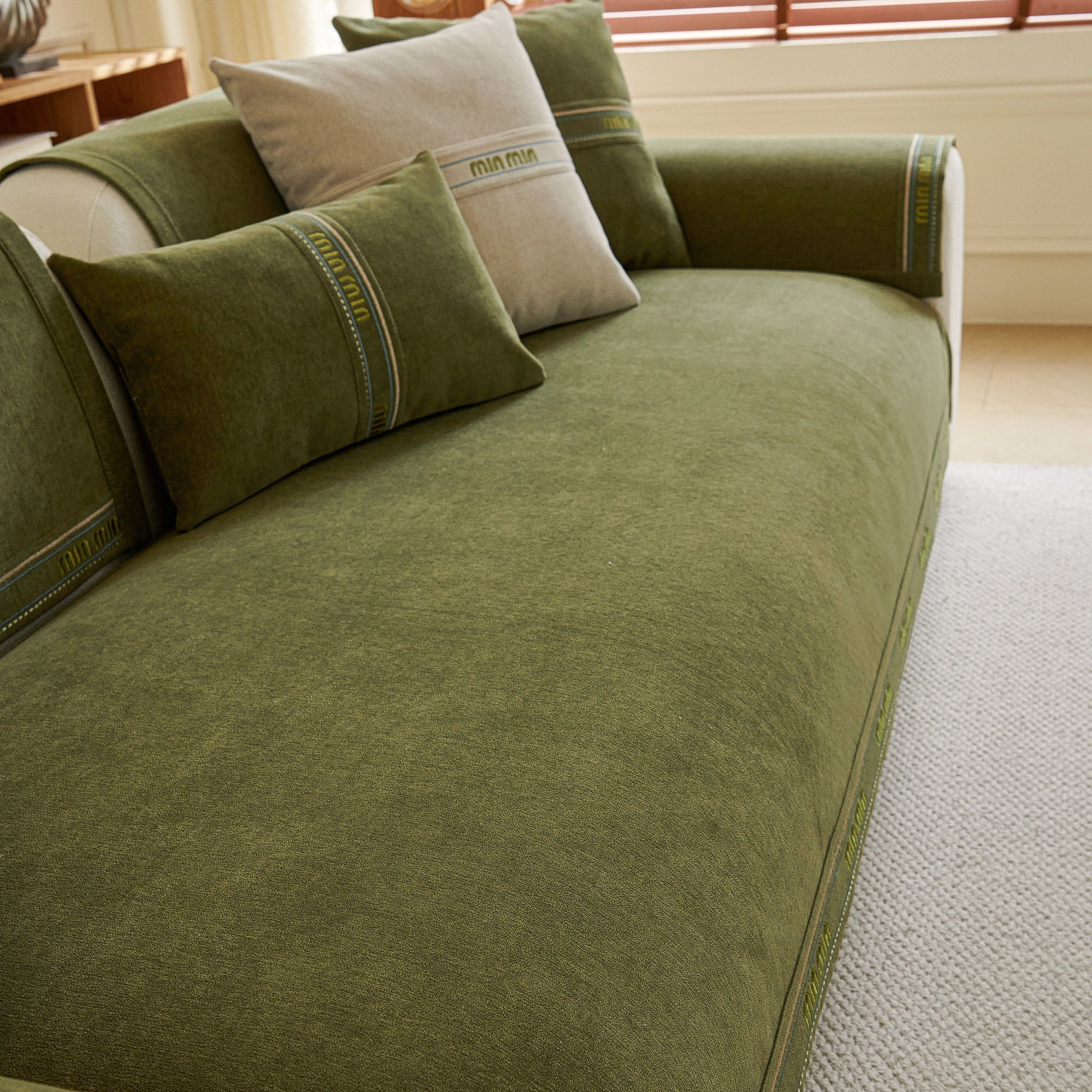 Green chenille sofa cover pet mat on sectional couch, non-slip couch protector for sectional & L-shaped sofas with decorative pillows.
