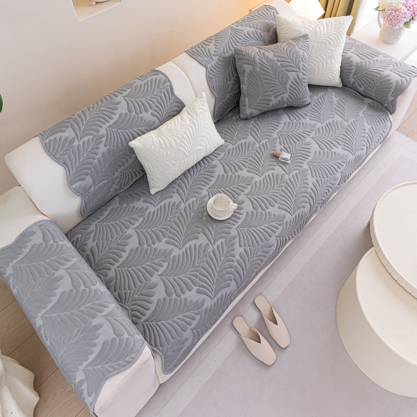 Sofa Cover for Leather & Fabric Couches, 3D Leaf Embossed Quilted Furniture Covers on a grey sofa