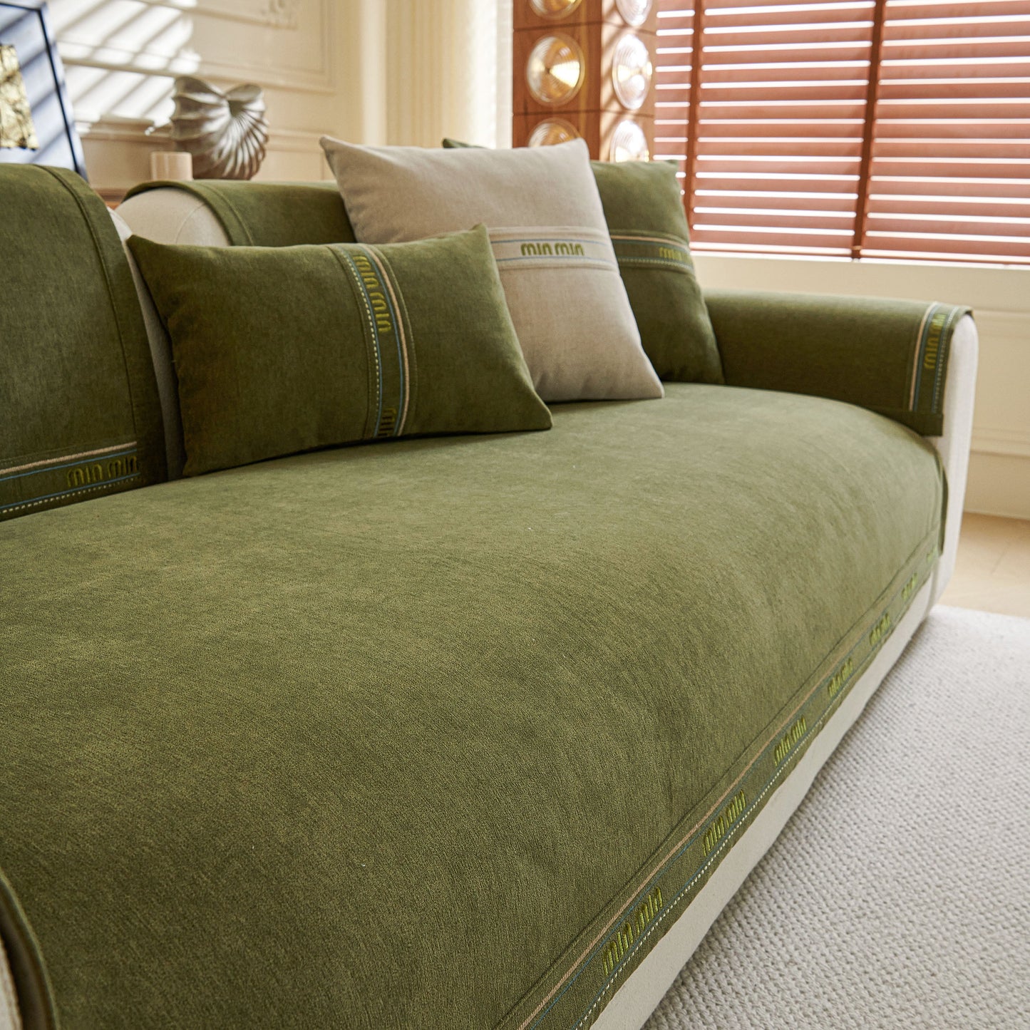 Chenille Sofa Cover Pet Mat, Non-Slip Couch Protector for Sectional & L-Shaped Sofas in textured green fabric with pillows.