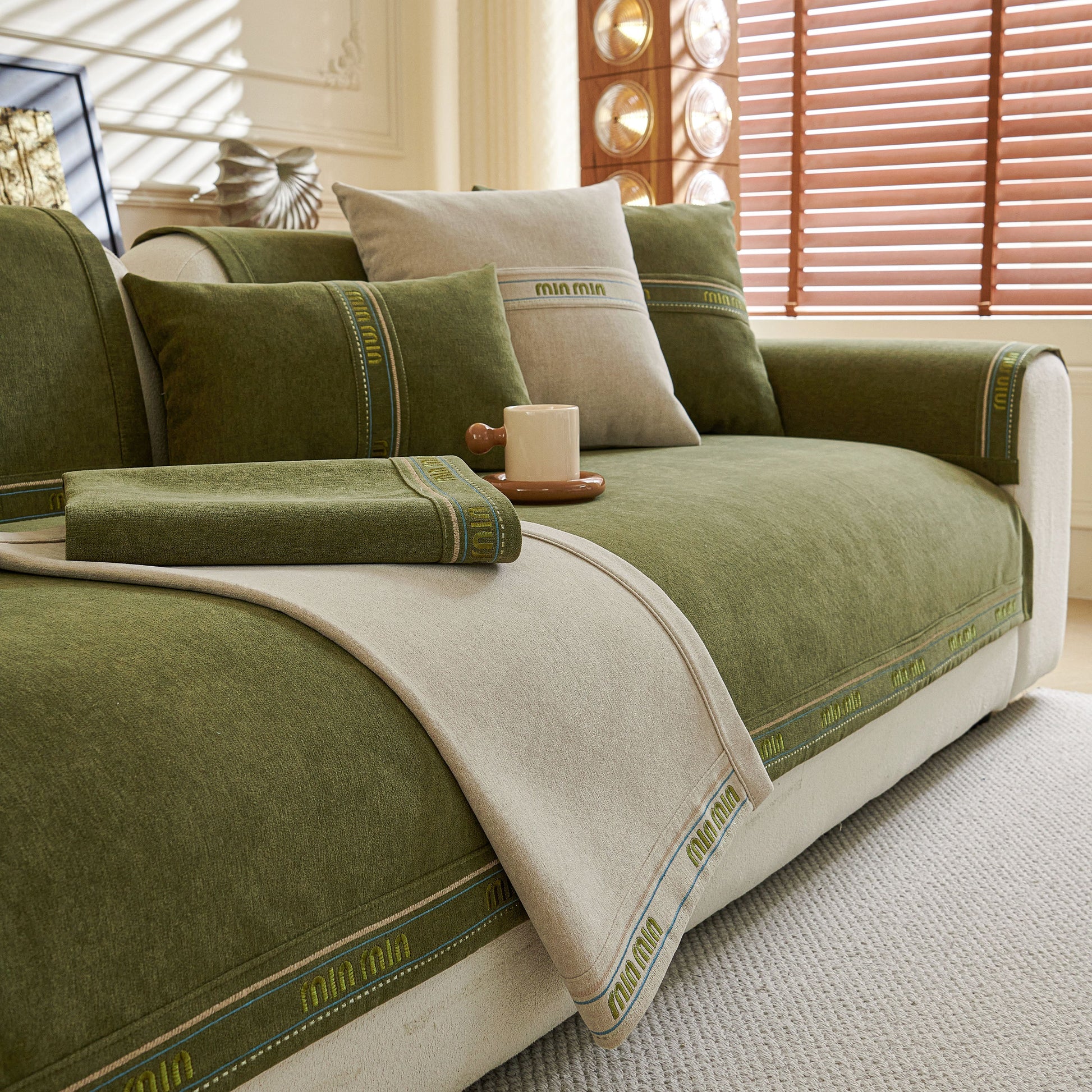 Chenille Sofa Cover Pet Mat, Non-Slip Couch Protector for Sectional & L-Shaped Sofas in green and beige on a stylish couch.