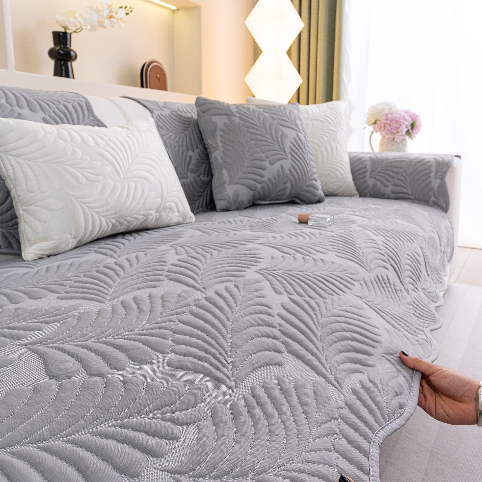 Sofa Cover for Leather & Fabric Couches, 3D Leaf Embossed Quilted Furniture Covers with silicone anti-slip backing in gray.