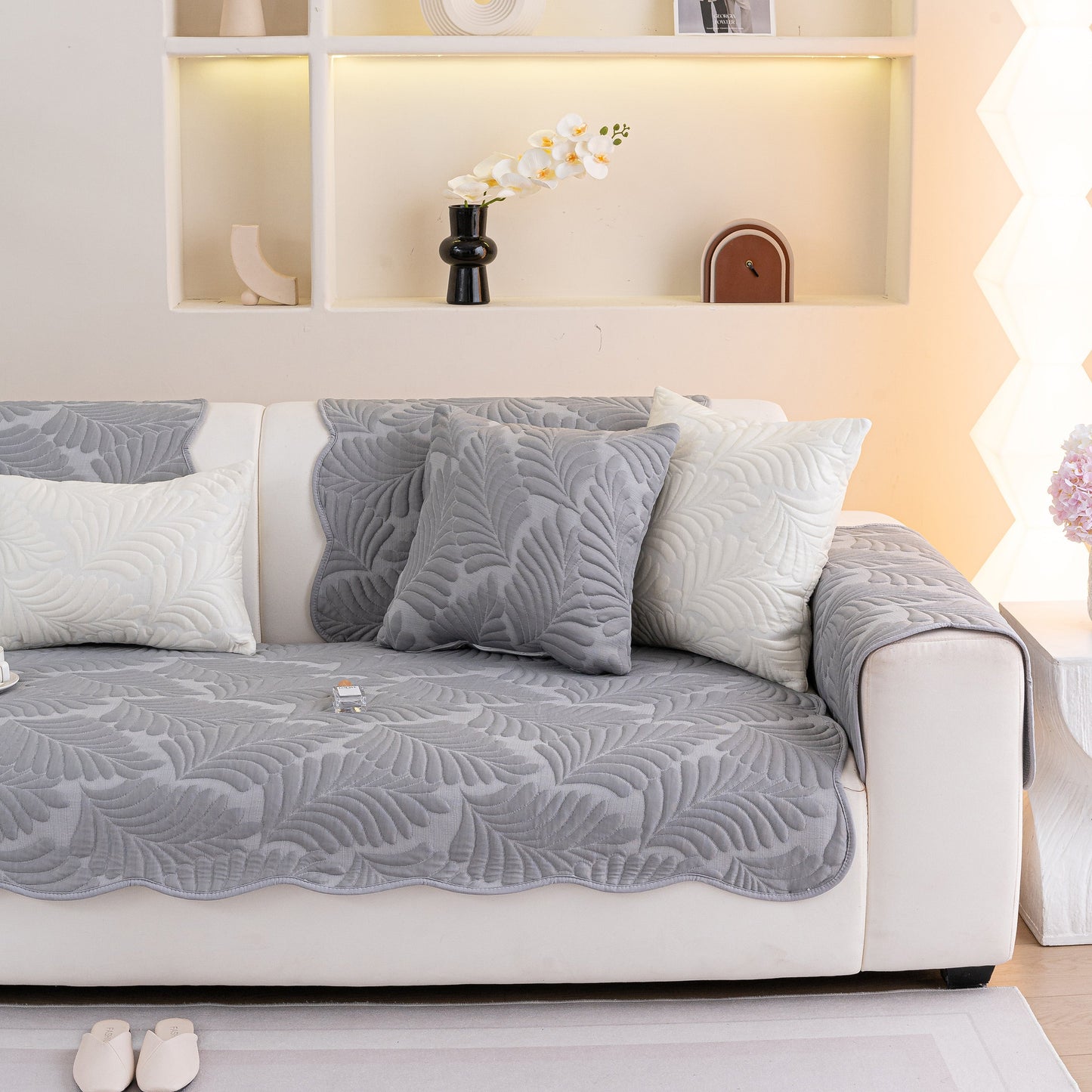 Sofa Cover for Leather & Fabric Couches, 3D Leaf Embossed Quilted Furniture Covers in gray on a white sofa.