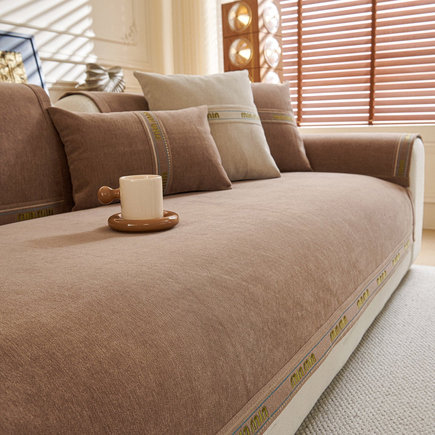 Chenille Sofa Cover Pet Mat, Non-Slip Couch Protector for Sectional & L-Shaped Sofas on a styled brown couch setup.