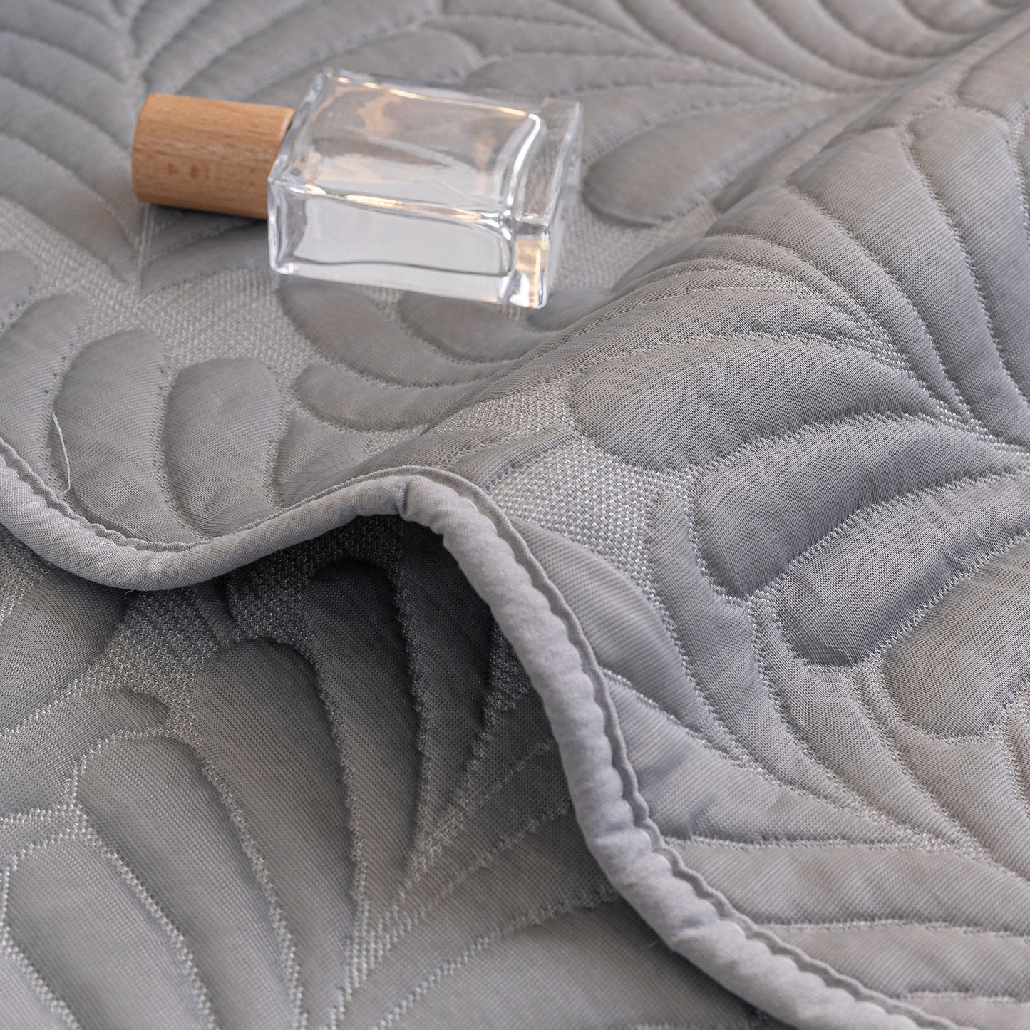 Sofa Cover for Leather & Fabric Couches, 3D Leaf Embossed Quilted Furniture Covers with anti-slip backing and wave-cut edge design.