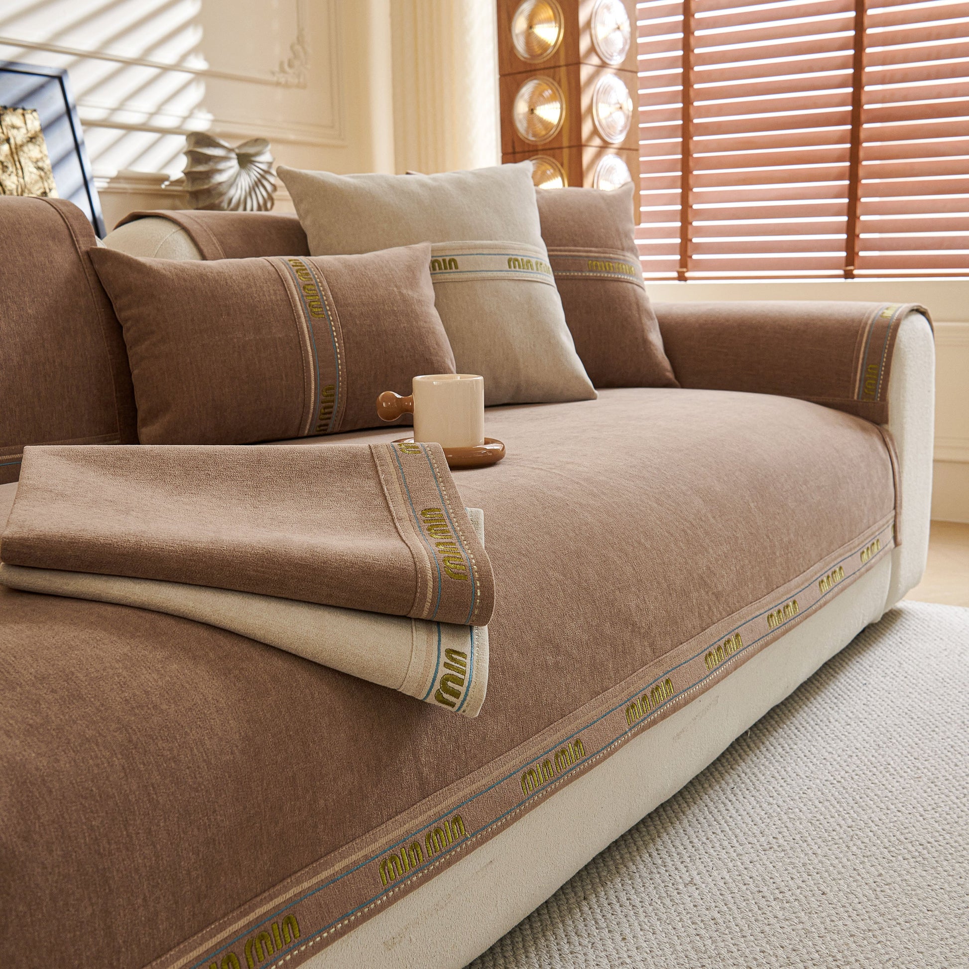 Chenille Sofa Cover Pet Mat, Non-Slip Couch Protector for Sectional & L-Shaped Sofas in brown chenille fabric on a living room couch.