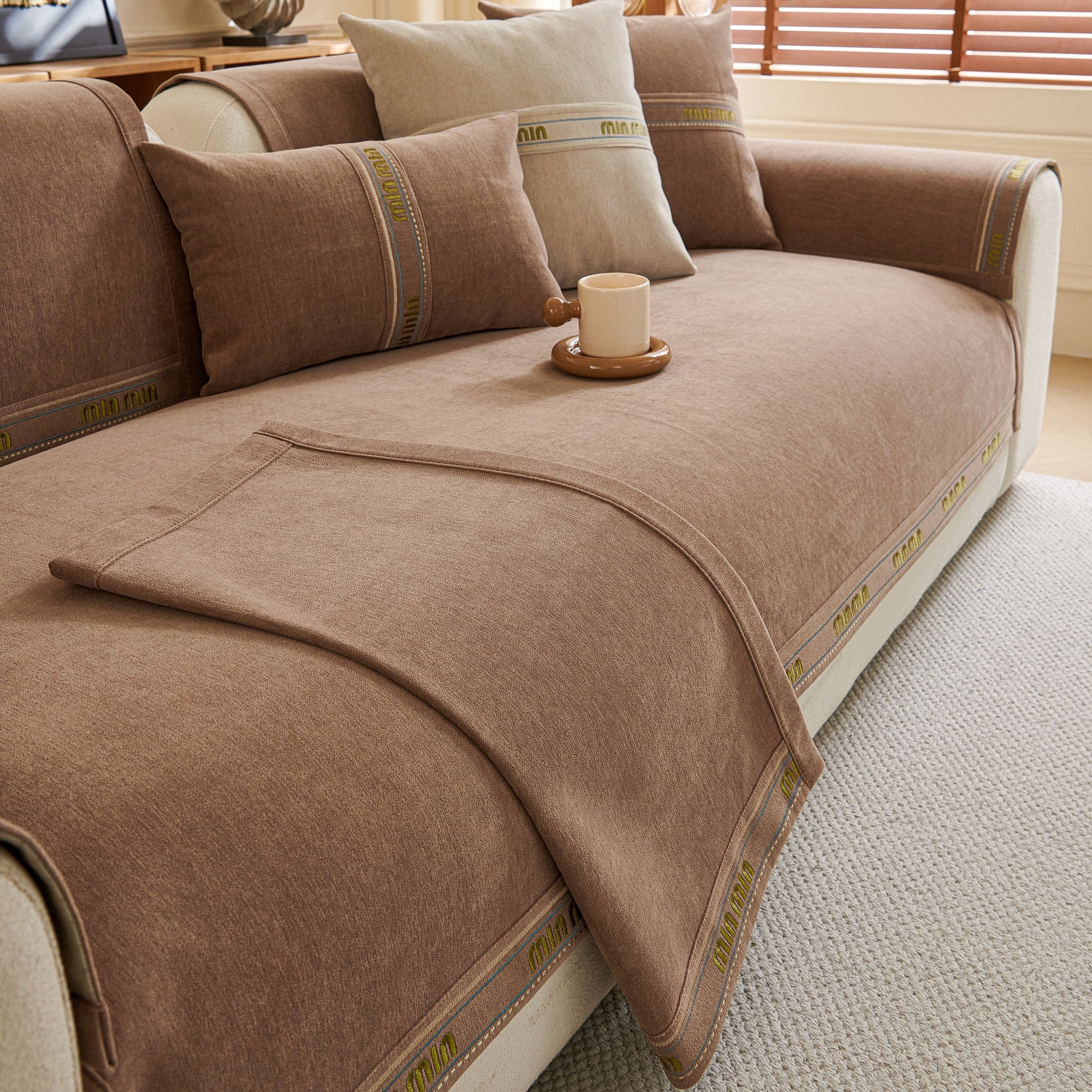 Chenille Sofa Cover Pet Mat, Non-Slip Couch Protector for Sectional & L-Shaped Sofas on a beige couch with decorative pillows.