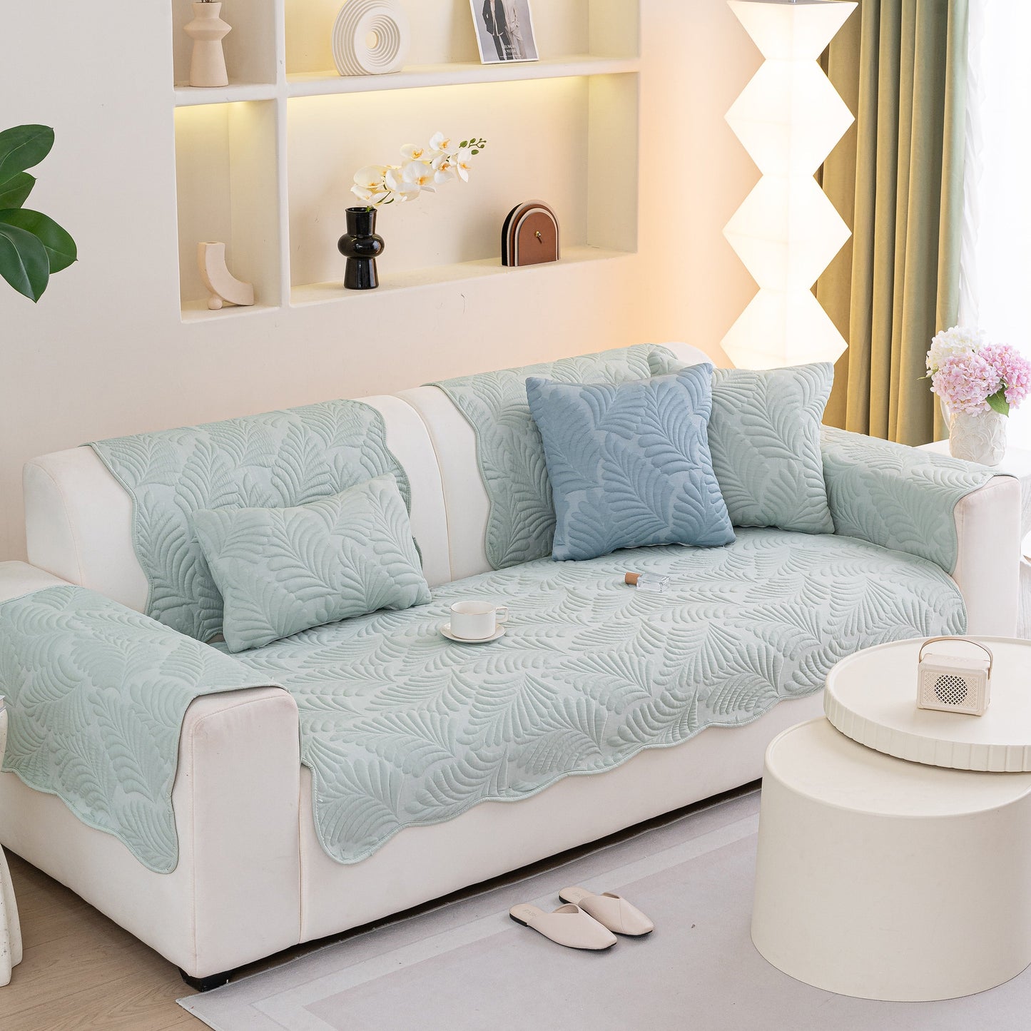 Sofa Cover for Leather & Fabric Couches, 3D Leaf Embossed Quilted Furniture Covers with anti-slip backing, displayed in living room.