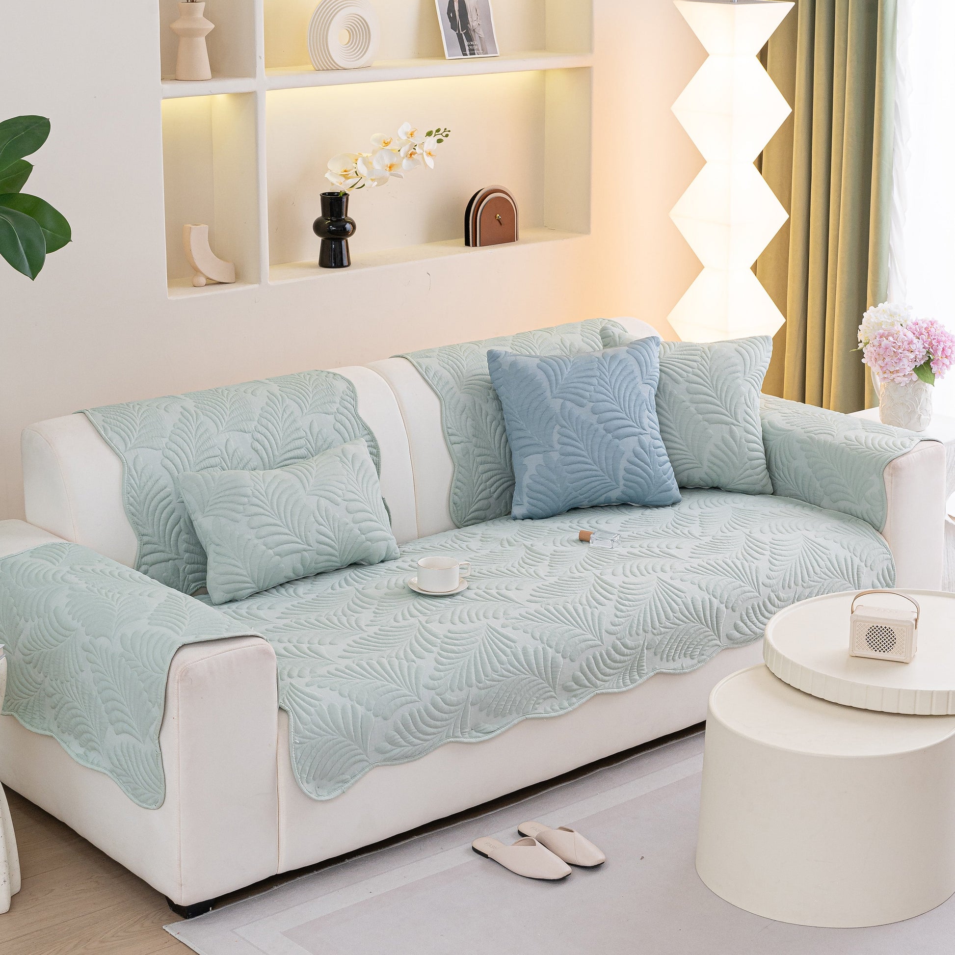 Sofa Cover for Leather & Fabric Couches, 3D Leaf Embossed Quilted Furniture Covers with anti-slip backing, displayed in living room.
