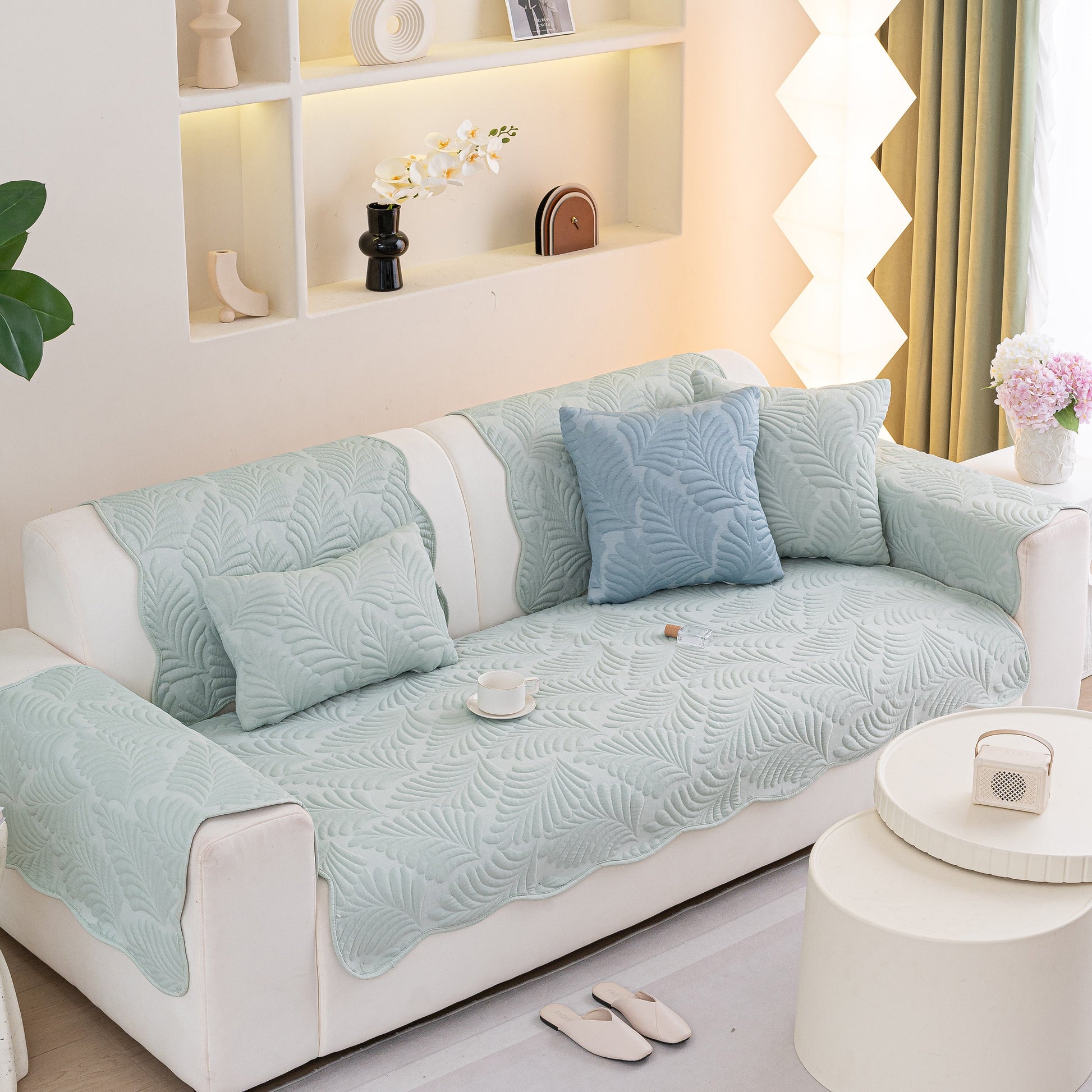 Sofa Cover for Leather & Fabric Couches, 3D Leaf Embossed Quilted Furniture Covers displayed on a white sofa with cushions.