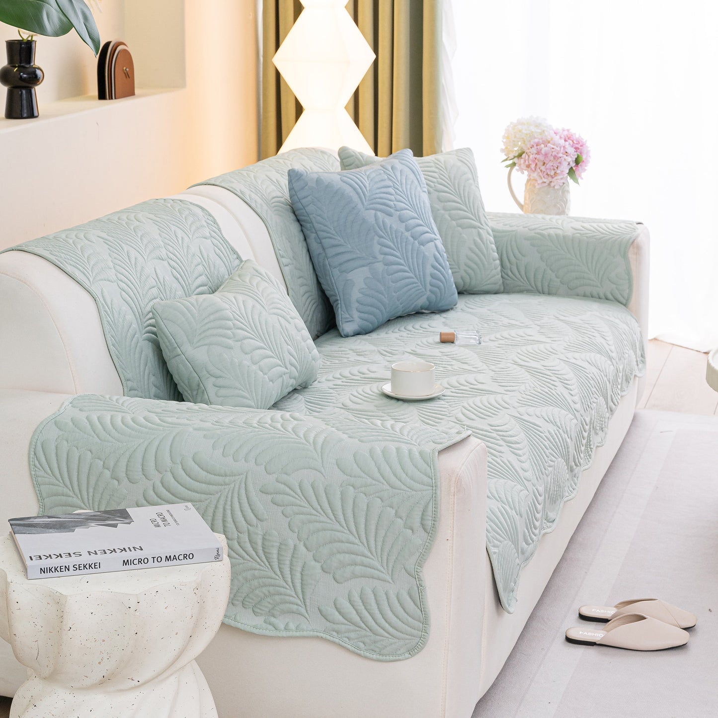 Sofa Cover for Leather & Fabric Couches, 3D Leaf Embossed Quilted Furniture Covers in living room with cushions and decor.