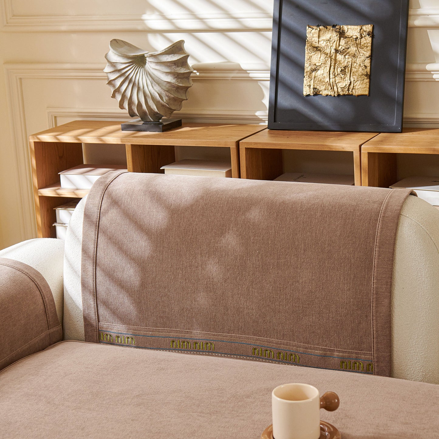 Chenille Sofa Cover Pet Mat, Non-Slip Couch Protector for Sectional & L-Shaped Sofas on a beige couch in a stylish living room.