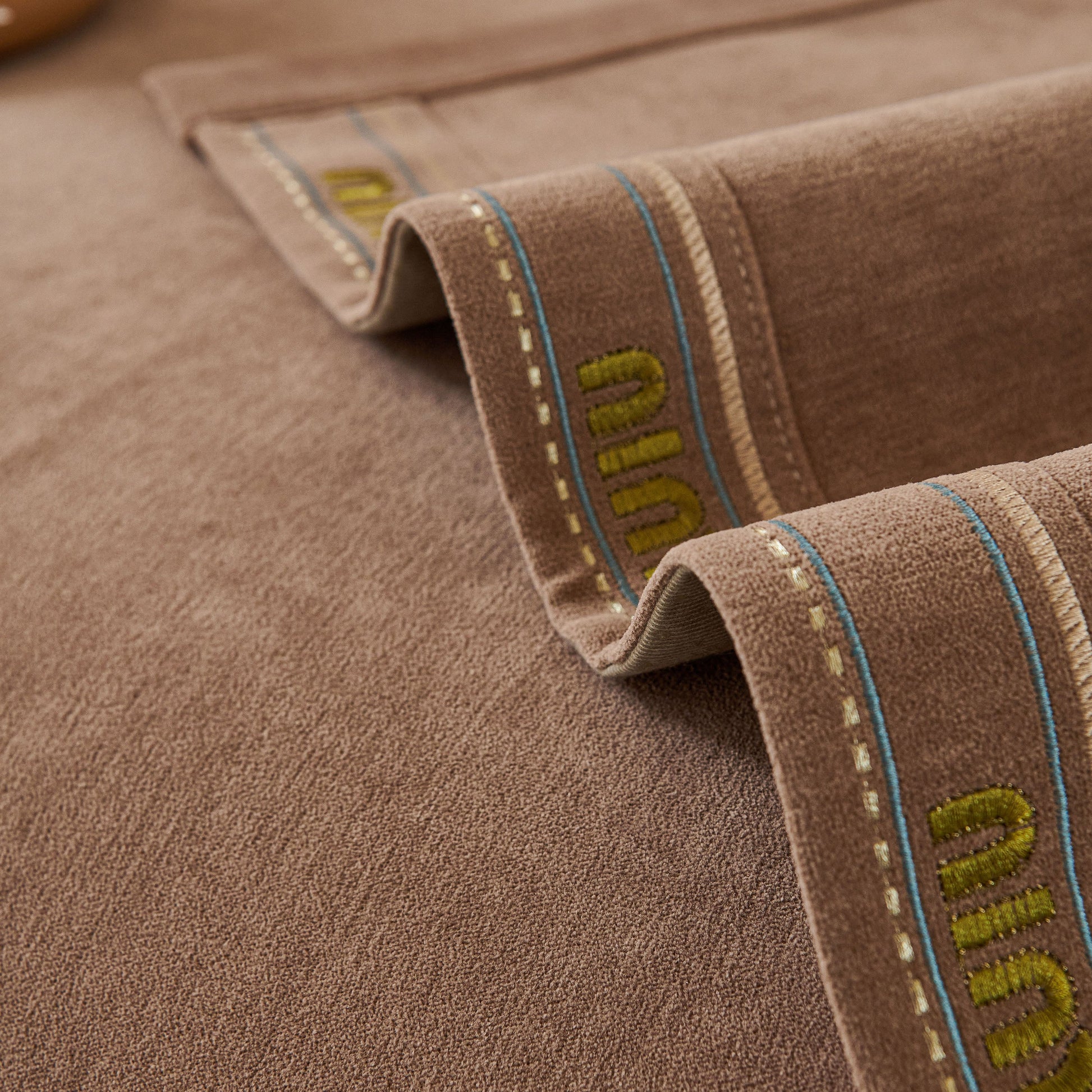 Close-up of Chenille Sofa Cover Pet Mat, Non-Slip Couch Protector for Sectional & L-Shaped Sofas with textured chenille fabric.