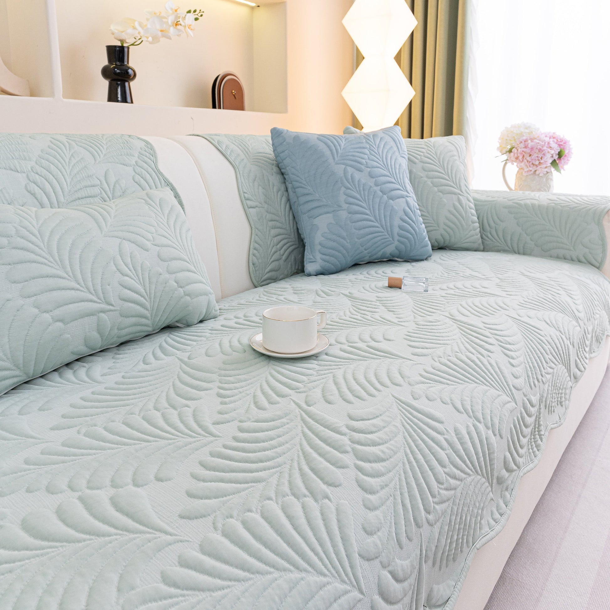 Sofa Cover for Leather & Fabric Couches, 3D Leaf Embossed Quilted Furniture Covers featuring anti-slip silicone backing on a sofa.