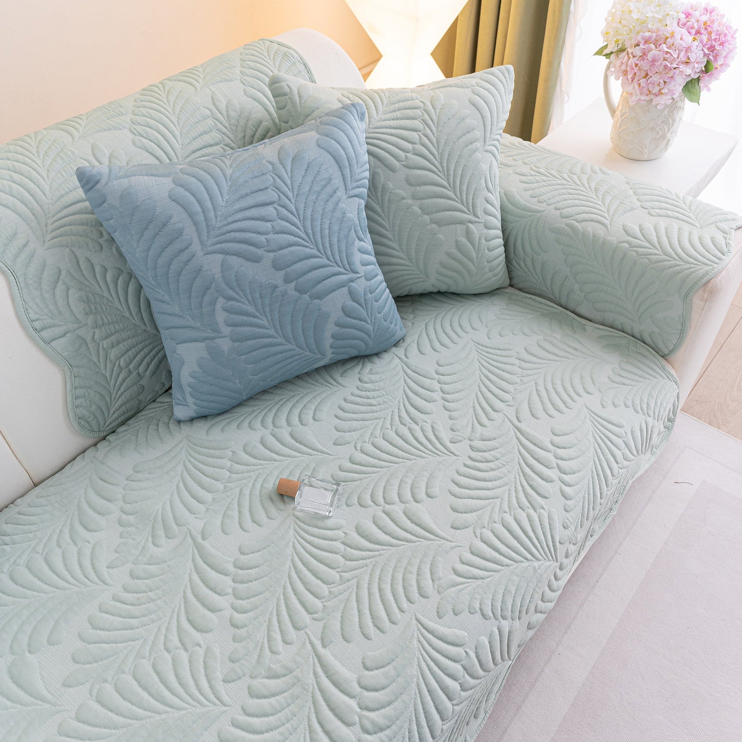 Sofa Cover for Leather & Fabric Couches, 3D Leaf Embossed Quilted Furniture Covers on a living room couch.