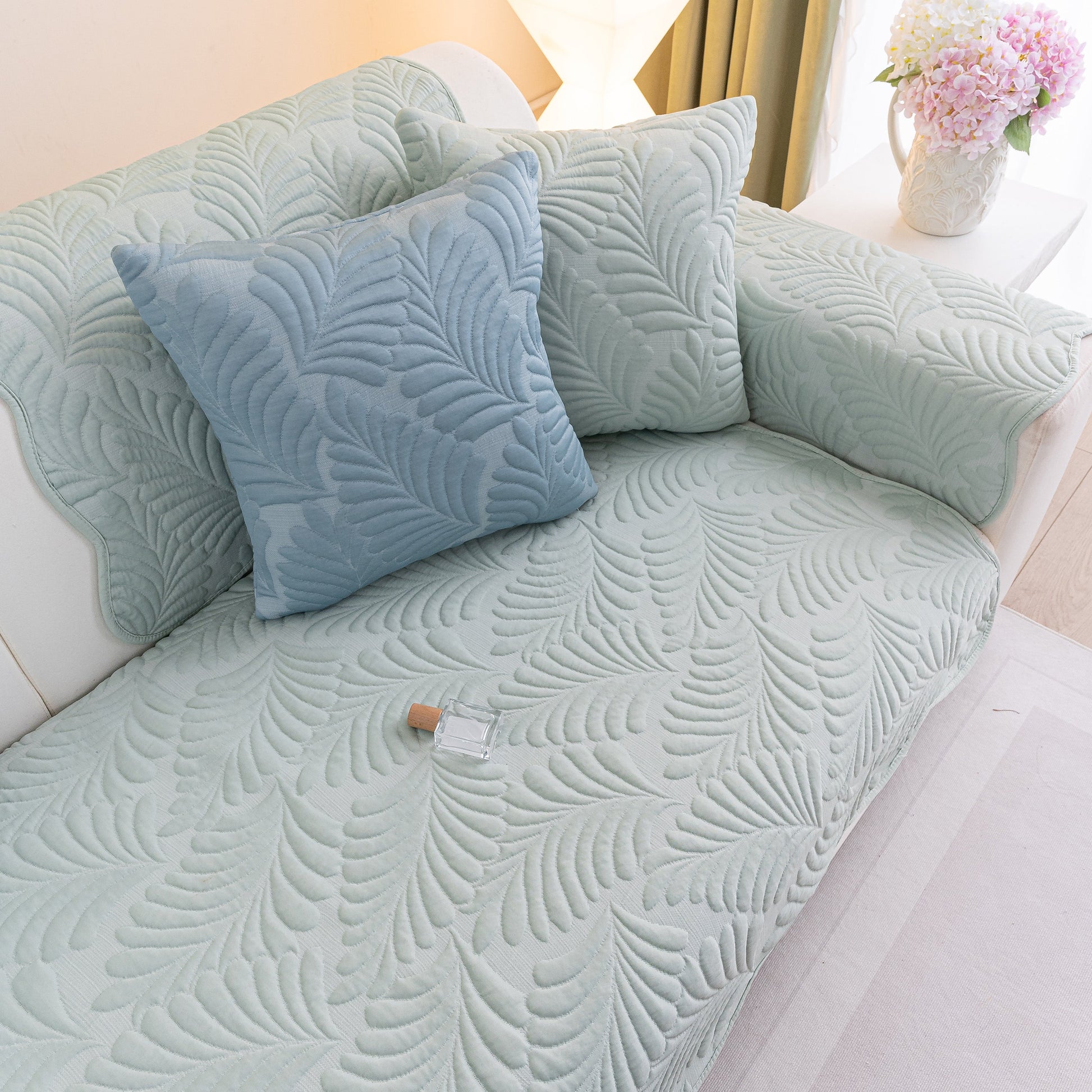Sofa Cover for Leather & Fabric Couches, 3D Leaf Embossed Quilted Furniture Covers on a living room couch.