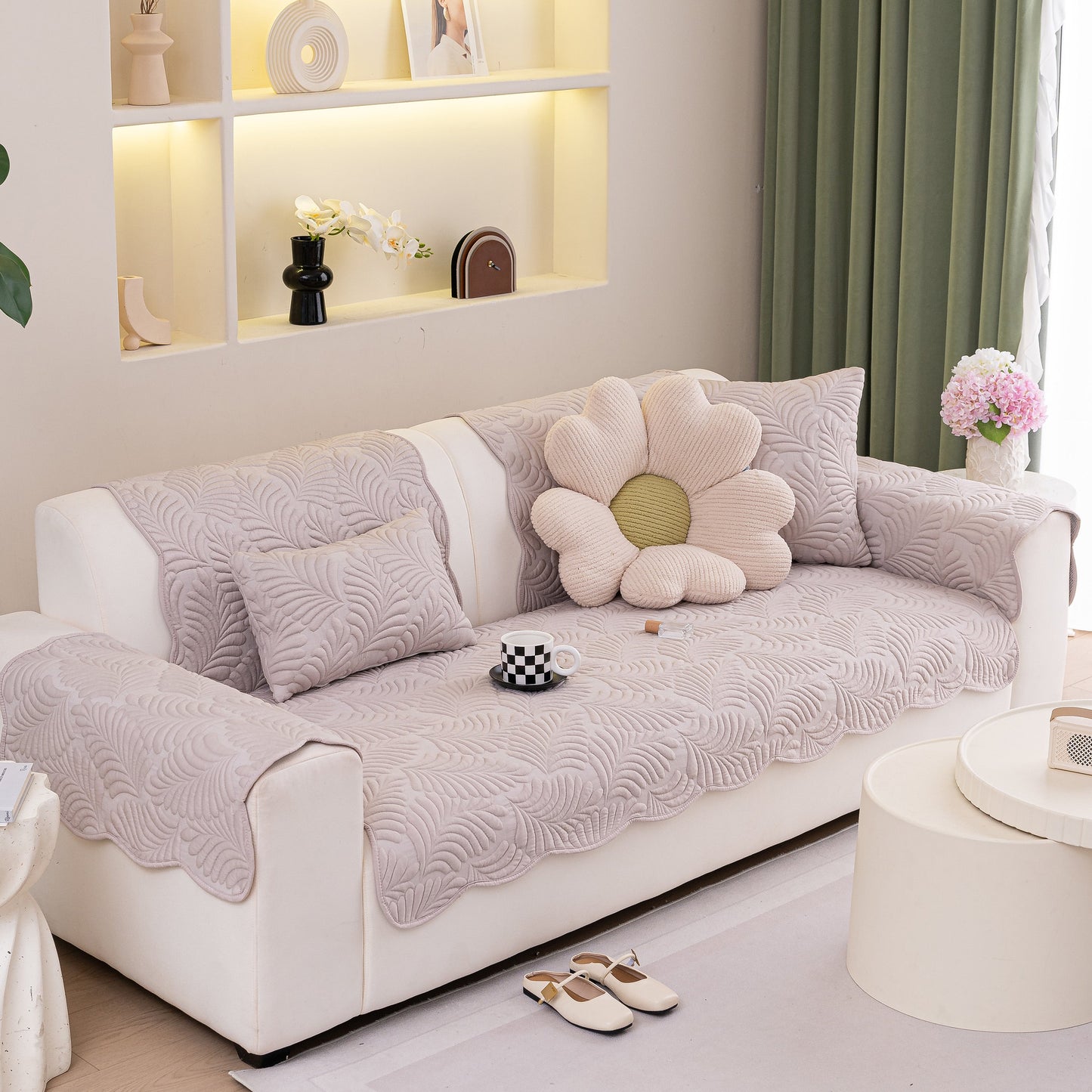 Sofa Cover for Leather & Fabric Couches, 3D Leaf Embossed Quilted Furniture Covers on a beige couch with floral pillow