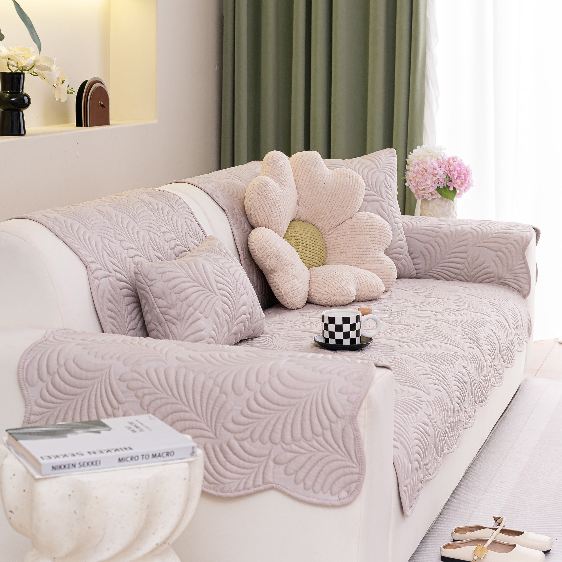 Sofa Cover for Leather & Fabric Couches, 3D Leaf Embossed Quilted Furniture Covers in a living room setting, with floral pillow accents.