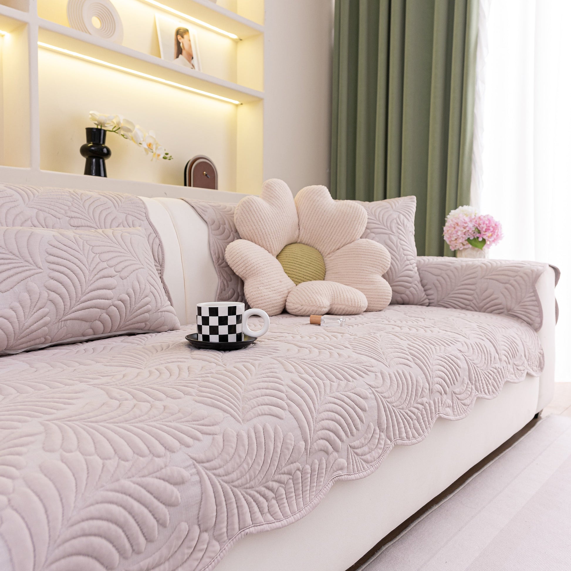 Sofa Cover for Leather & Fabric Couches, 3D Leaf Embossed Quilted Furniture Covers on a sofa in a living room setting.