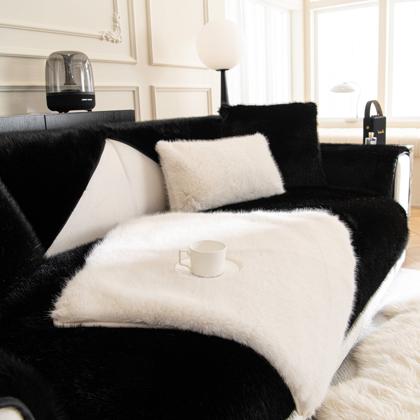 Faux Mink Velvet Luxury Fluffy Sofa Cushion, Winter Warm Thick Plush Non-slip Sofa Covers on a modern black and white sofa.