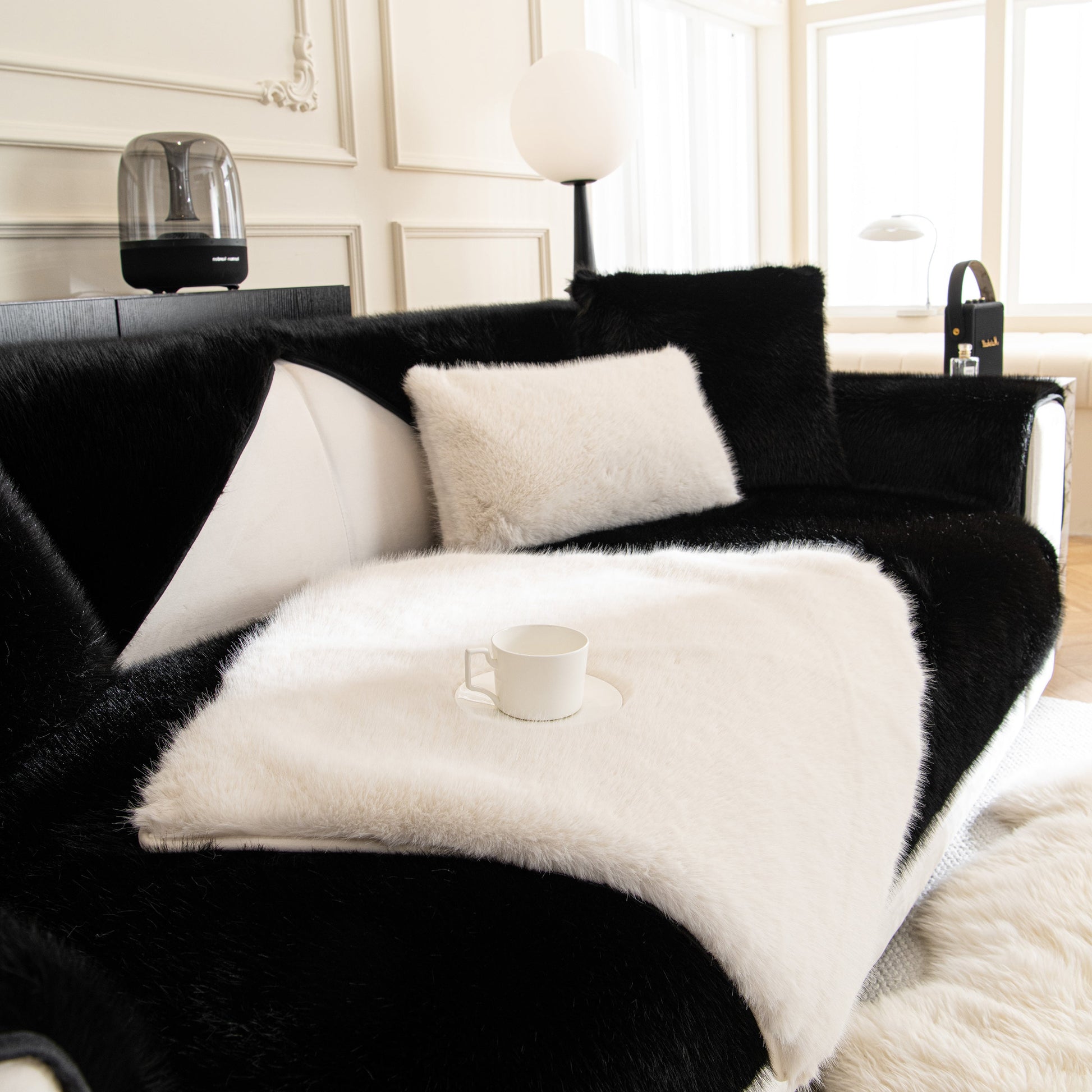 Faux Mink Velvet Luxury Fluffy Sofa Cushion, Winter Warm Thick Plush Non-slip Sofa Covers on a modern black and white sofa.