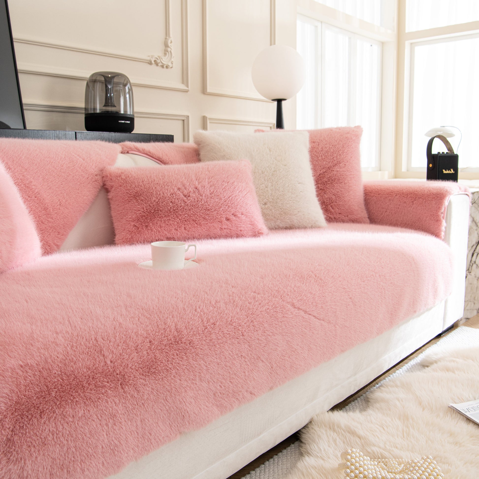 Faux Mink Velvet Luxury Fluffy Sofa Cushion, Winter Warm Thick Plush Non-slip Sofa Covers in pink on a modern white sofa.