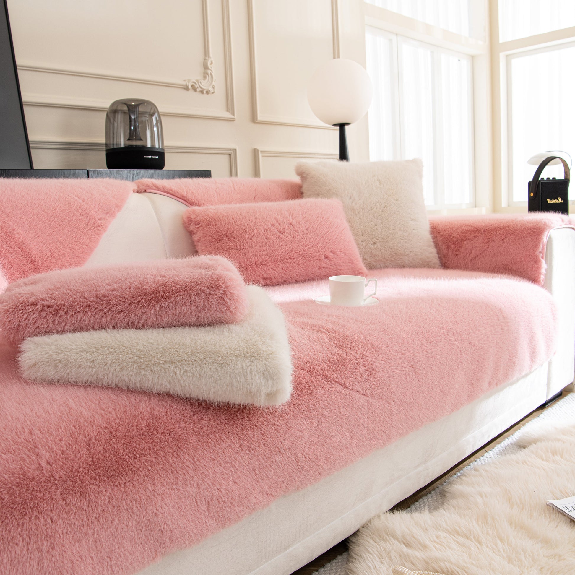 Faux Mink Velvet Luxury Fluffy Sofa Cushion, Winter Warm Thick Plush Non-slip Sofa Covers in pink on a modern white sofa.
