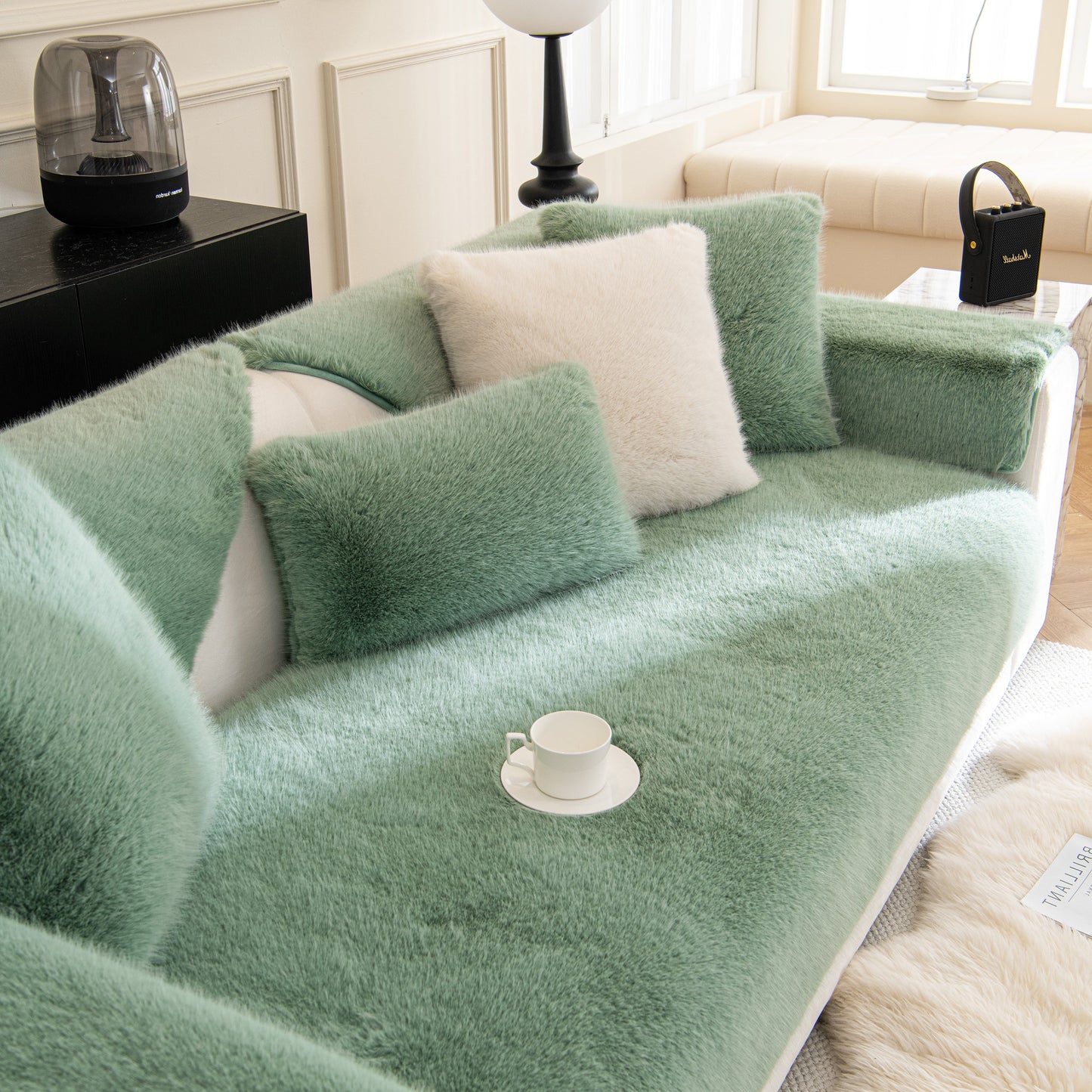 Faux Mink Velvet Luxury Fluffy Sofa Cushion, Winter Warm Thick Plush Non-slip Sofa Covers on a stylish green sofa in a cozy living room.