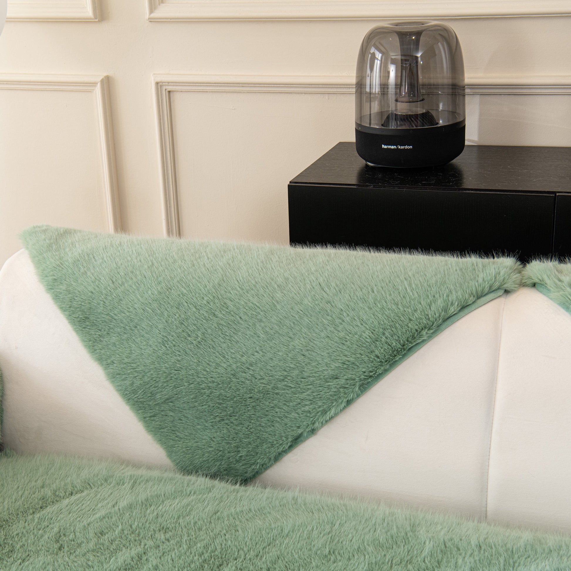 Faux Mink Velvet Luxury Fluffy Sofa Cushion, Winter Warm Thick Plush Non-slip Sofa Covers in green on a white sofa.