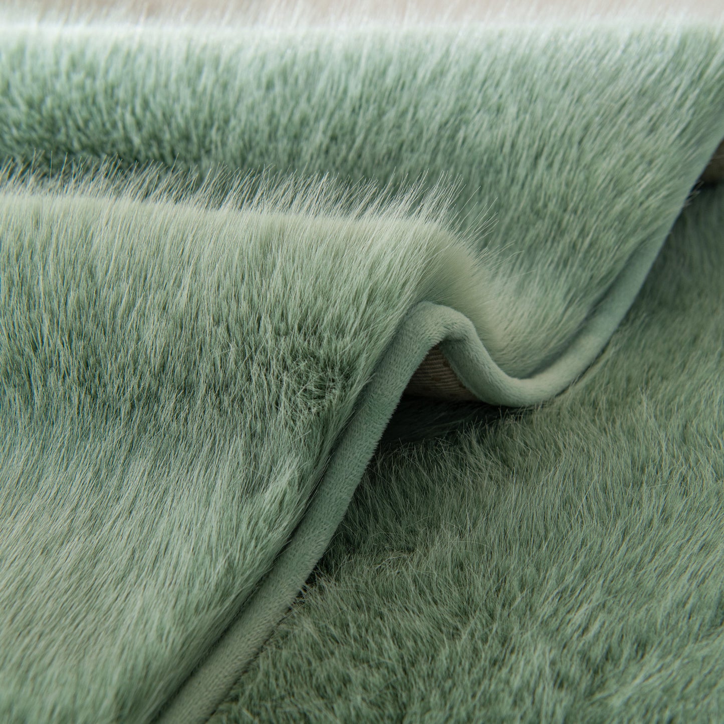 Faux Mink Velvet Luxury Fluffy Sofa Cushion, Winter Warm Thick Plush Non-slip Sofa Covers in soft green texture.