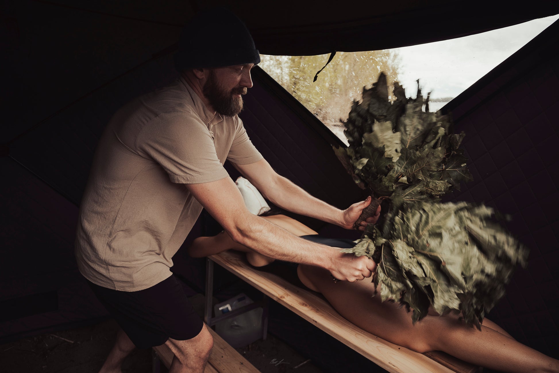 Person using Oak Venik - Whisk for sauna massage and toxin removal.
