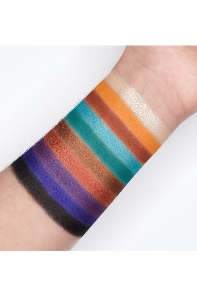 Swatches of Go2 DA BOMB! - GES04 eyeshadow palette showcasing vibrant matte and shimmer shades on forearm.