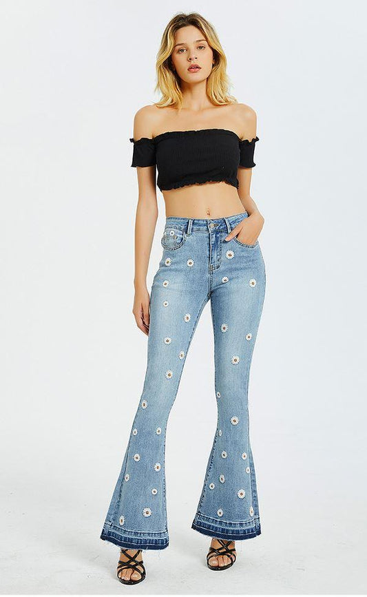Model wearing Daisy Bloom Wide Leg Jeans with 3D daisy embroidery, featuring a retro-inspired wide-leg silhouette and slimming fit.