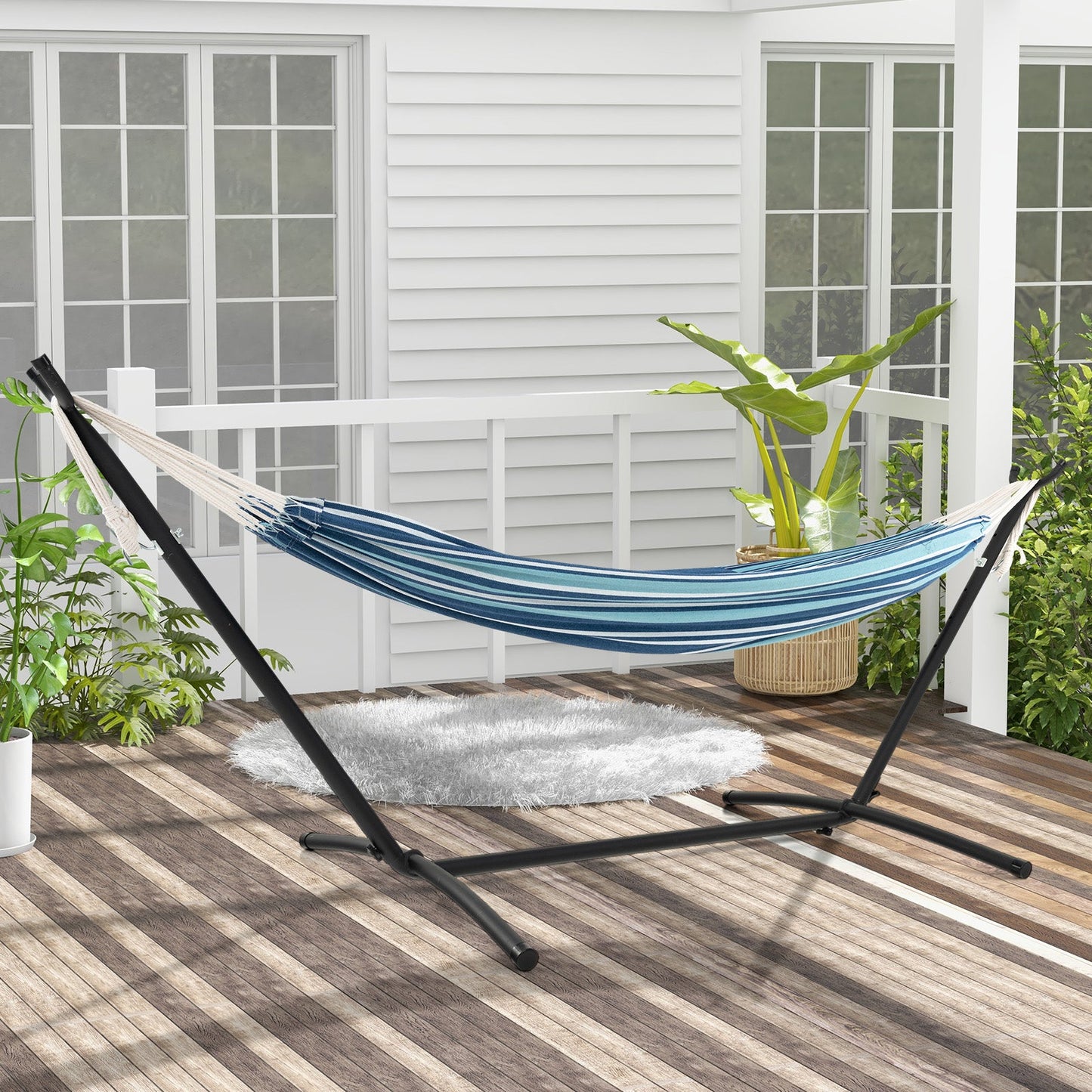 Portable Indoor Outdoor 2-Person Double Hammock Set with Stand and Carrying Cases-Blue on patio with plants