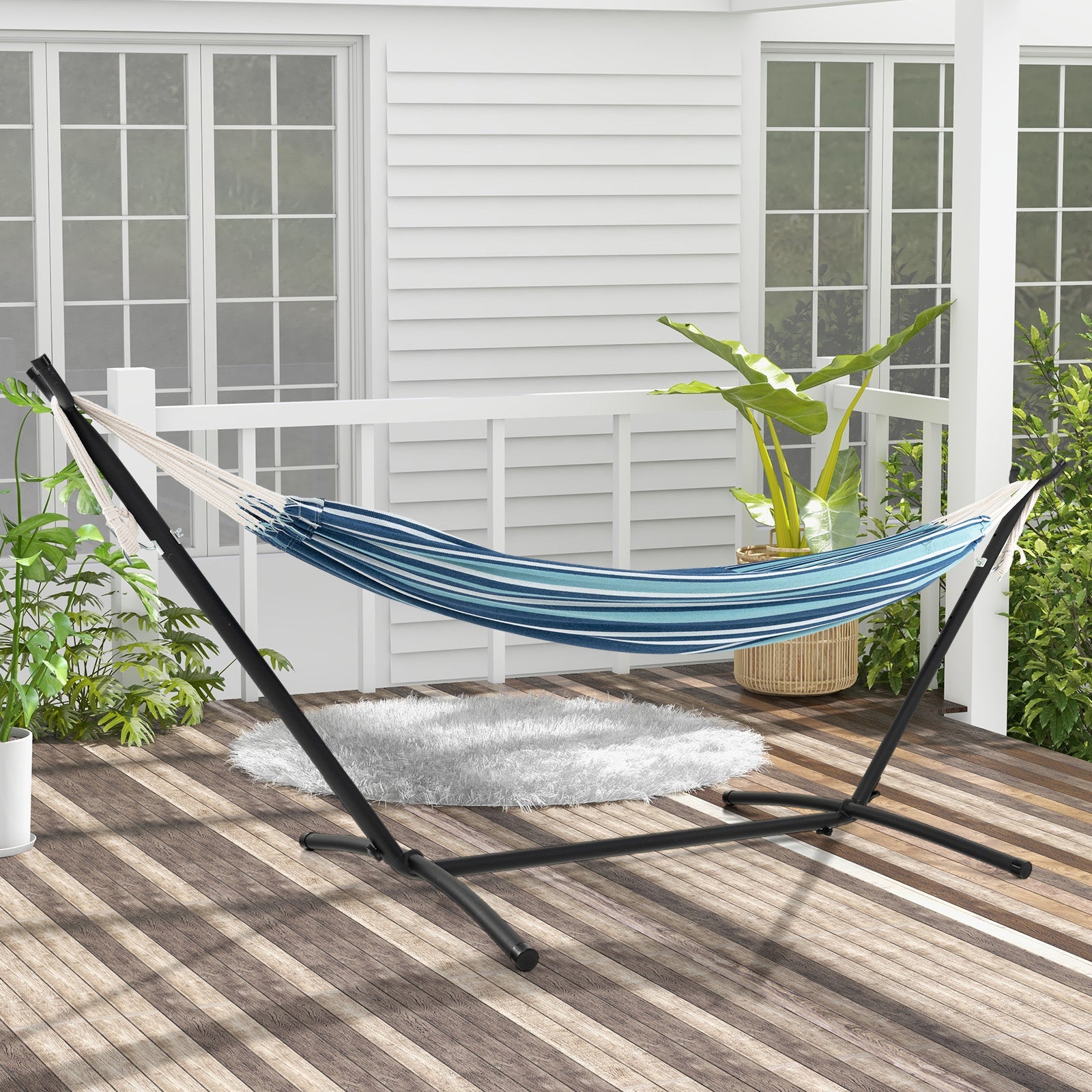 Portable Indoor Outdoor 2-Person Double Hammock Set with Stand and Carrying Cases-Blue on patio with plants