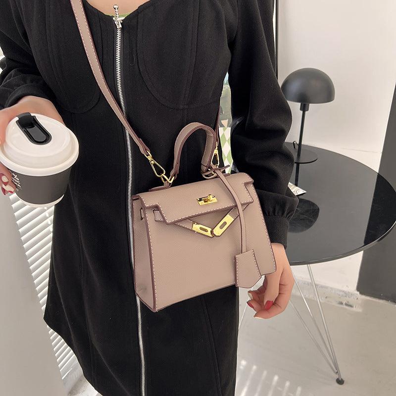 Luxury Cowgirl Kelly Purse – Trendy, High-Fashion Leather Handbag with Adjustable Strap, held by a person in a stylish black outfit