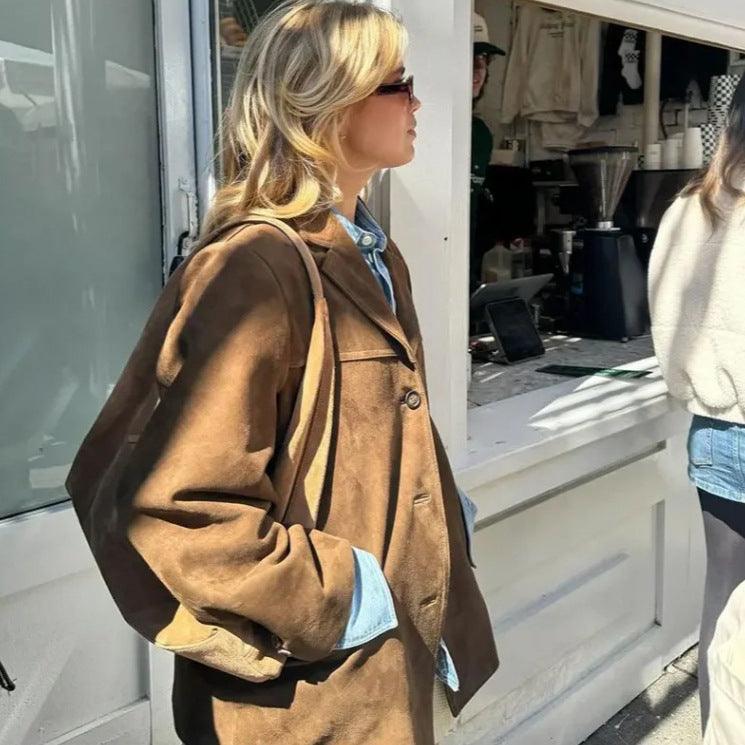 Stylish woman wearing Timeless Suede Princess Jacket - Chic Mocha and Latte Retro Jacket for Women with sunlit backdrop.
