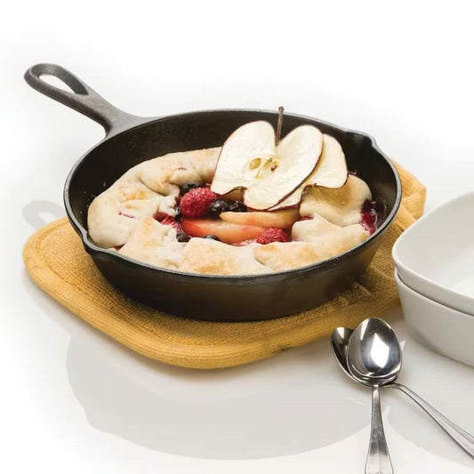 8-inch Pre-Seasoned Cast Iron Skillet Frying Pan with Pour Spouts Made in USA on a countertop with a fruit dessert